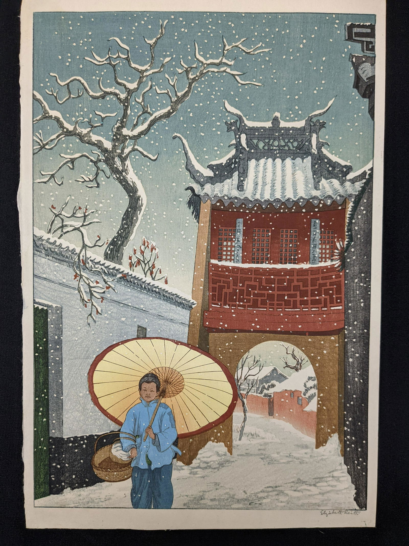 Elizabeth Keith. Original color woodblock depicting a young boy with umbrella walking in the snow (1 of 4)