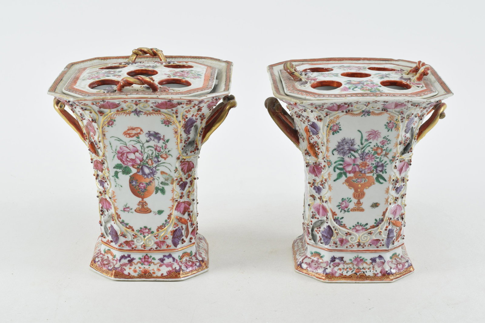 Pair of 18th century Chinese export relief decorated porcelain cache pots. Squirrel and vine relief: Pair of 18th century Chinese export relief decorated porcelain cache pots. Squirrel and vine relief decoration. Rope twist handles and finials on covers. Chips on top of bases. Repairs and losses to a