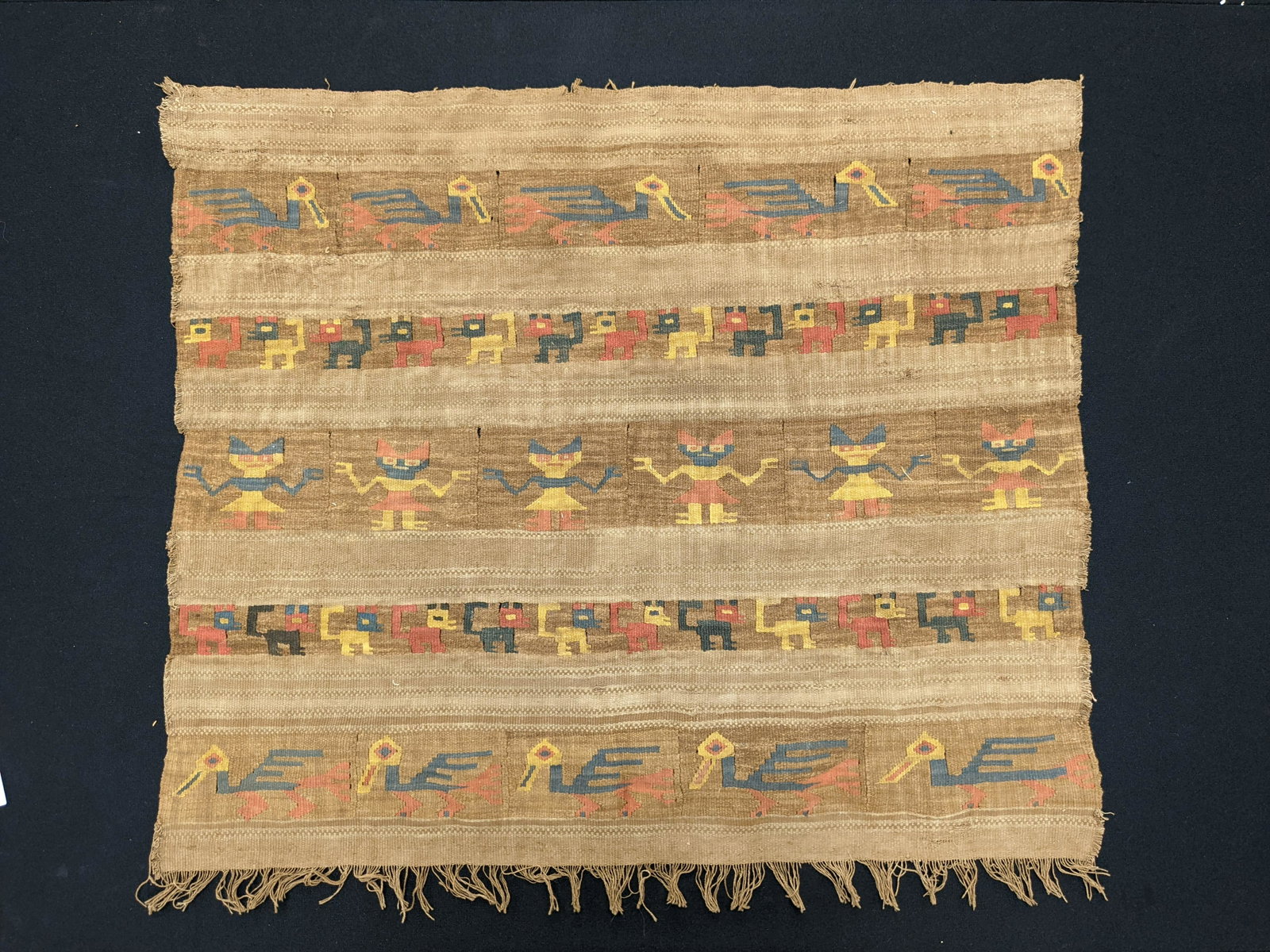 Late pre-columbian flat weave panel depicting 5 rows of alternating stylized figures, birds, and: Late pre-columbian flat weave panel depicting 5 rows of alternating stylized figures, birds, and monkeys. Some splits in seams. Slight losses in several spots. Overall good condition. 24.5 x 27.75in i