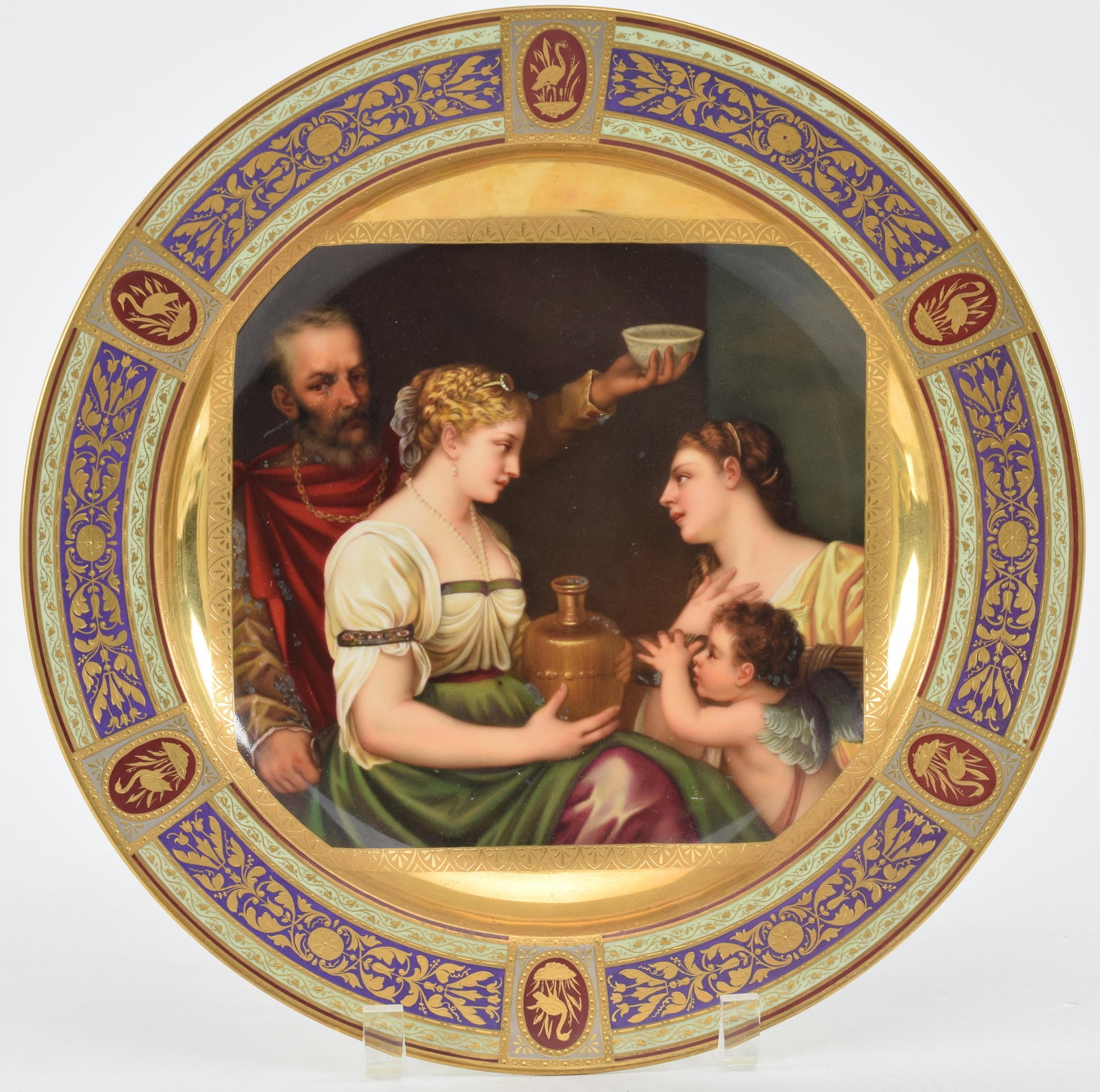 Royal Vienna hand painted plate with allegory and fine gilt borders. Figures at center with urn and: Royal Vienna hand painted plate with allegory and fine gilt borders. Figures at center with urn and cherub. Red and light green borders with gilt decorations including crane medallions. Minor wear to 