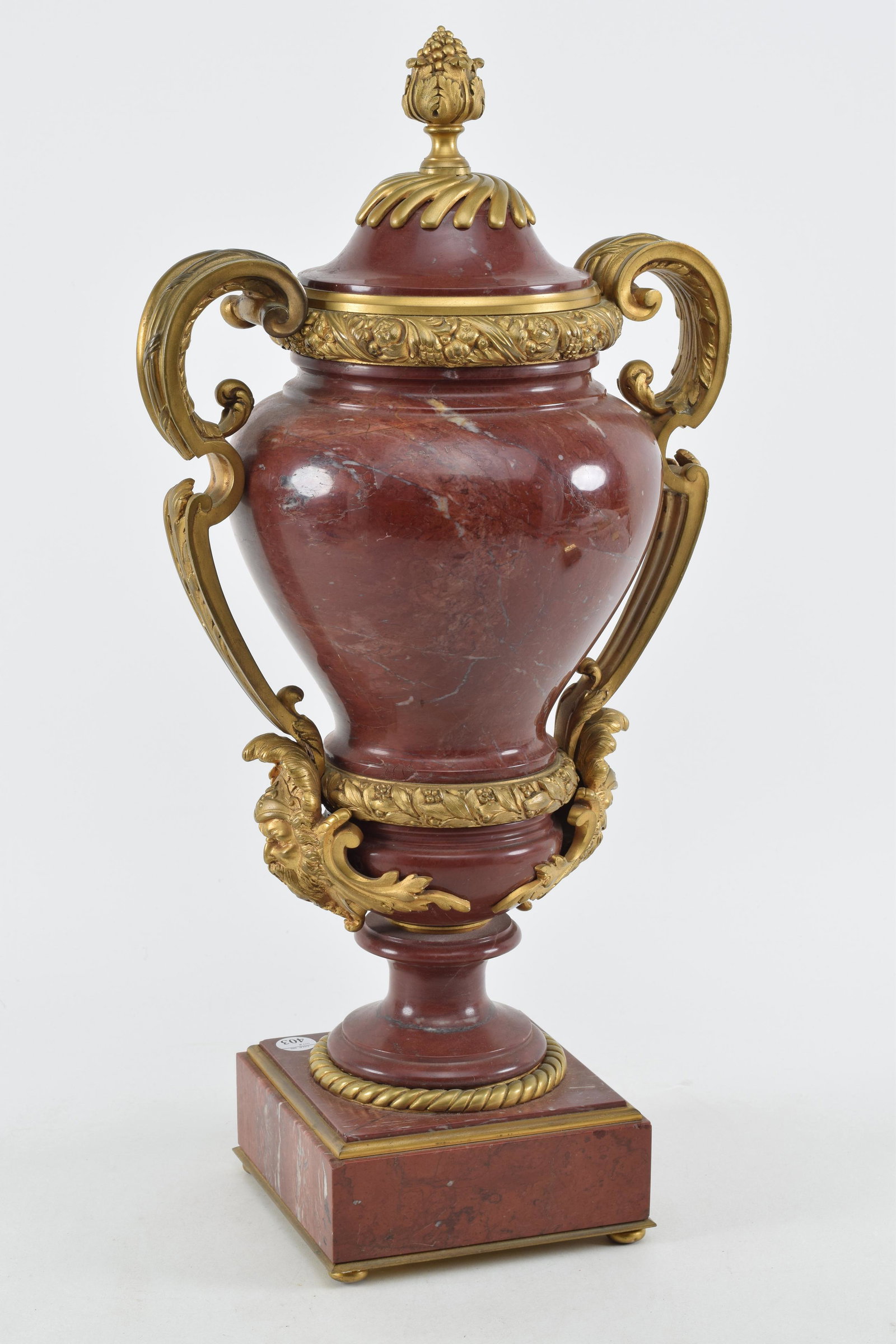 French red marble and ormolu mounted urn, late 19th Century. Variegated red marble with elaborate: French red marble and ormolu mounted urn, late 19th Century. Variegated red marble with elaborate gilt bronze mounts including pomegranate final, scrolled handles with warrior. Height 21.5 in.