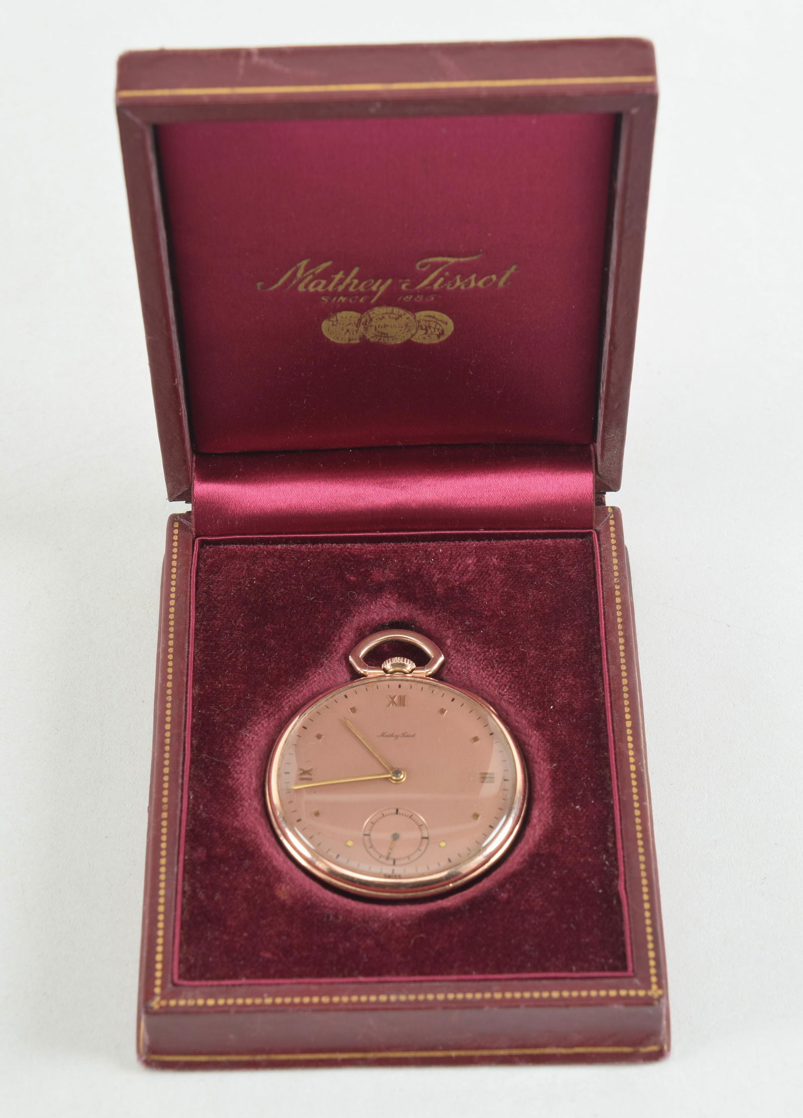 14K rose gold Mathey Tissot pocket watch. Wadsworth model. 17 jewels. Marked on inside cover 14K.: 14K rose gold Mathey Tissot pocket watch. Wadsworth model. 17 jewels. Marked on inside cover 14K. Runs then stops. 1.6in diameter. 36.7 grams. Original box. Monogrammed.