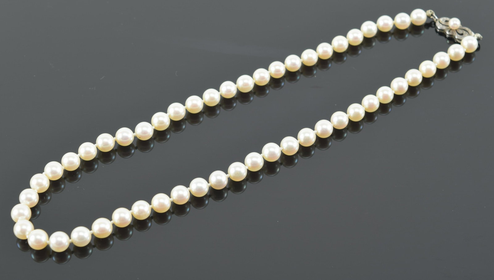 Mikimoto pearl necklace, 16 inches in original case. Silver clasp: Mikimoto pearl necklace, 16 inches in original case. Silver clasp