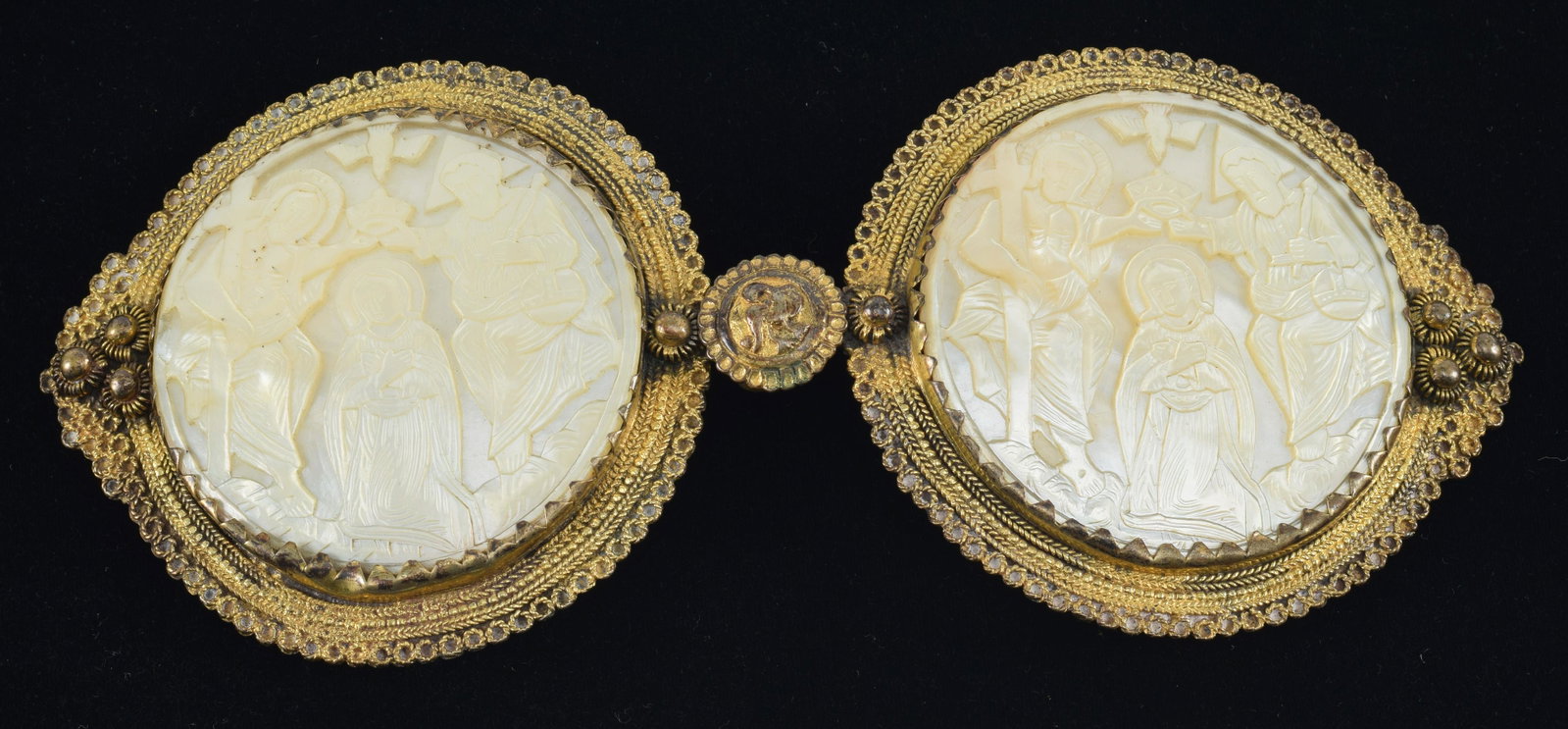 Early Byzantine style 2-part gilt copper buckle for a high ranking ecclesiastical figure. Carved: Early Byzantine style 2-part gilt copper buckle for a high ranking ecclesiastical figure. Carved mother of pearl medallions depicting the Annunciation of the Virgin. Fine patina. Bird decorated medall