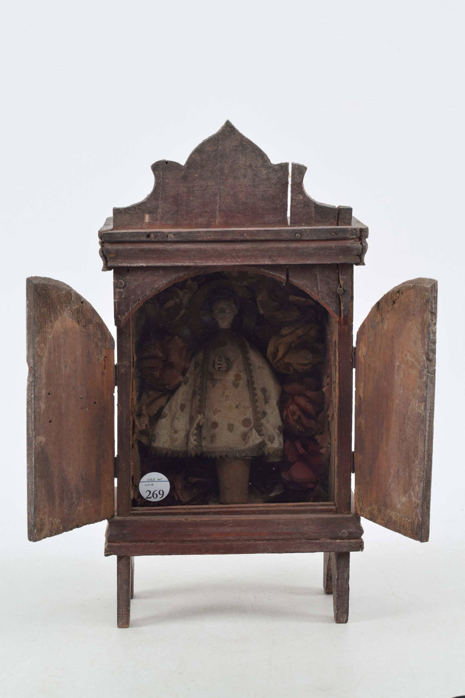 Early 20th century Mexican retablo altar shrine. Interior reveals a saint figure surrounded by paper: Early 20th century Mexican retablo altar shrine. Interior reveals a saint figure surrounded by paper flowers. Glass front. 12.5in high.