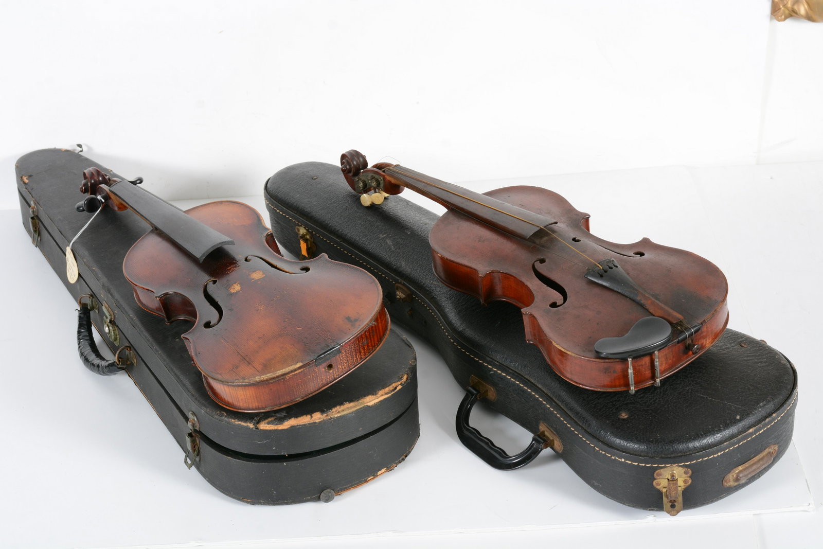 2 antique violins with cases. One with faux tiger grain. The other probably German, with various rep: 2 antique violins with cases. One with faux tiger grain. The other probably German, with various repairs and restoration. 14" and 23.25" lengths for each violin.