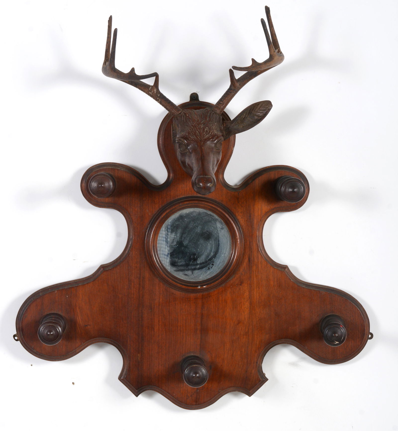Victorian walnut hat rack with carved elk head and central round mirror. Circa 1870. Elk horns cast: Victorian walnut hat rack with carved elk head and central round mirror. Circa 1870. Elk horns cast metal. Elk missing an ear. 30 x 29 in