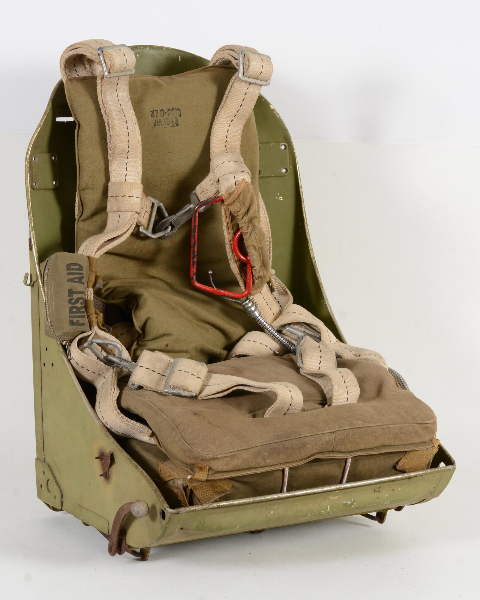 WWII Pilot Seat Frame with AN-6510 Seat Parachute Dated 1942. The Aluminum seat bucket has original: WWII Pilot Seat Frame with AN-6510 Seat Parachute Dated 1942. The Aluminum seat bucket has original green paint with all of its steel hardware but having rust and pitting from storage. The U.S.A.A.F. 