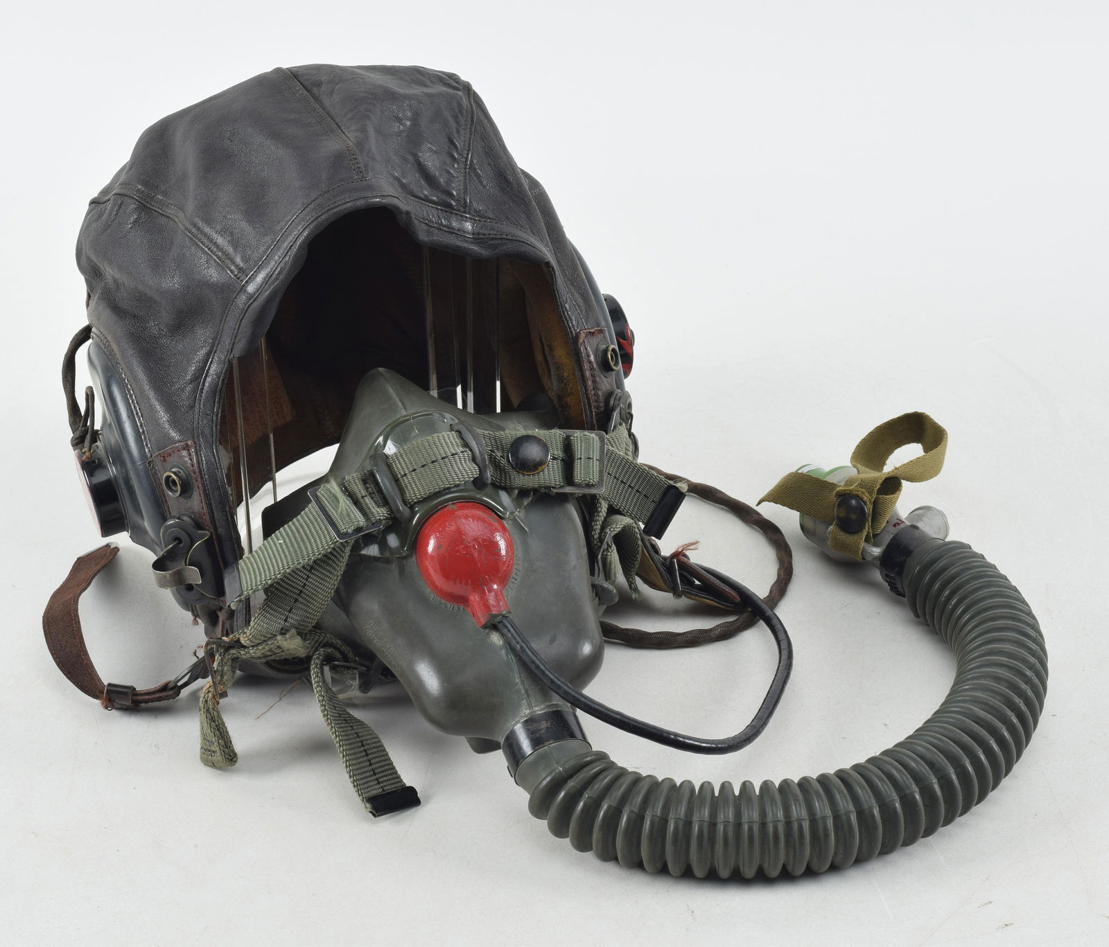 WWII U.S. Pilot Light Helmet with Radio Set and O2. This Army Air Force marked type A-11 size large: WWII U.S. Pilot Light Helmet with Radio Set and O2. This Army Air Force marked type A-11 size large headgear was made by "J.G. MENIHAN CORPORATION" and has a painted I'D of "JONS" to the left ear phon