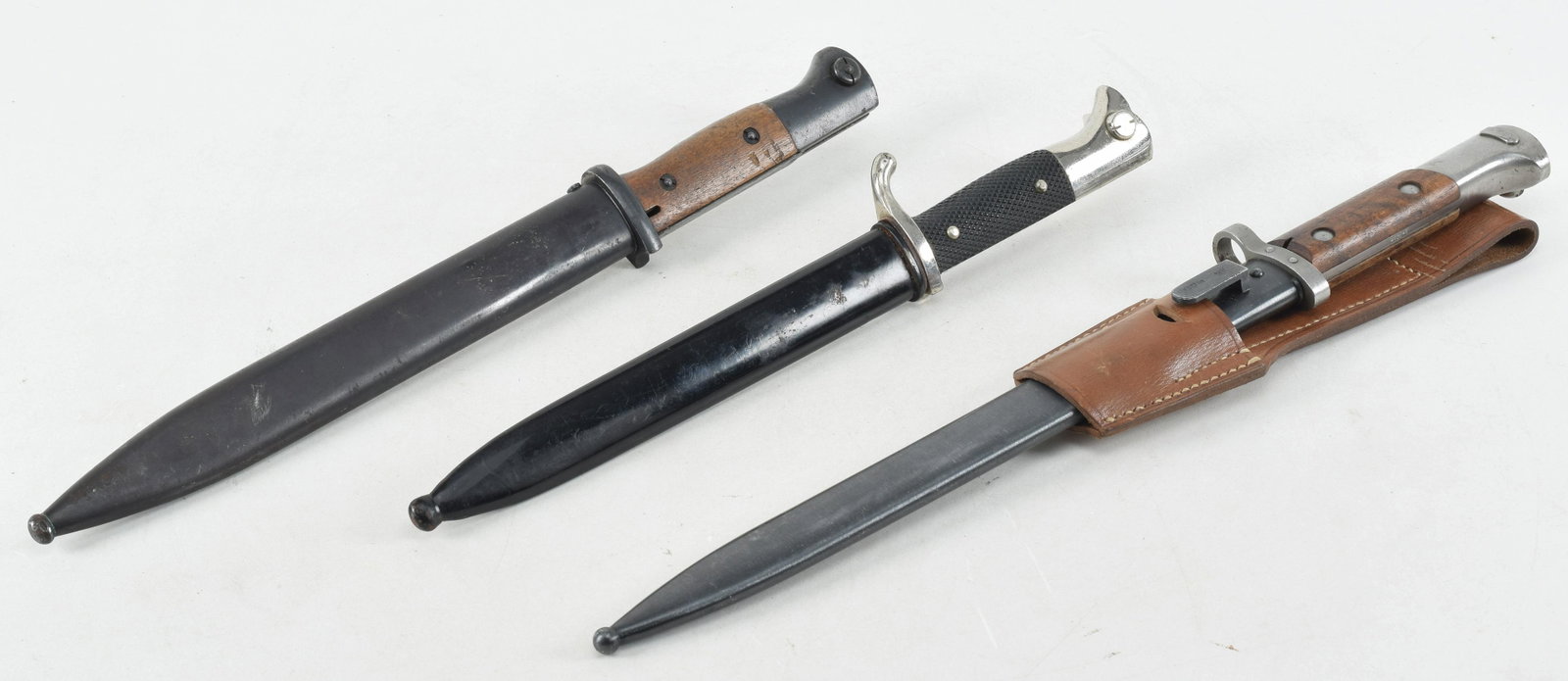 Lot of Three Bayonets. Two German WWII era K98 bayonets. One prewar made by F.W. Holler in 1934: Lot of Three Bayonets. Two German WWII era K98 bayonets. One prewar made by F.W. Holler in 1934 marked "S/175.K" with a non matching number scabbard by Herder dated 1936 stamped "S/240 1936" Blade has