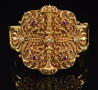 14K gold large heavy ornate bracelet with basket of flowers design and ruby and diamond mounts.