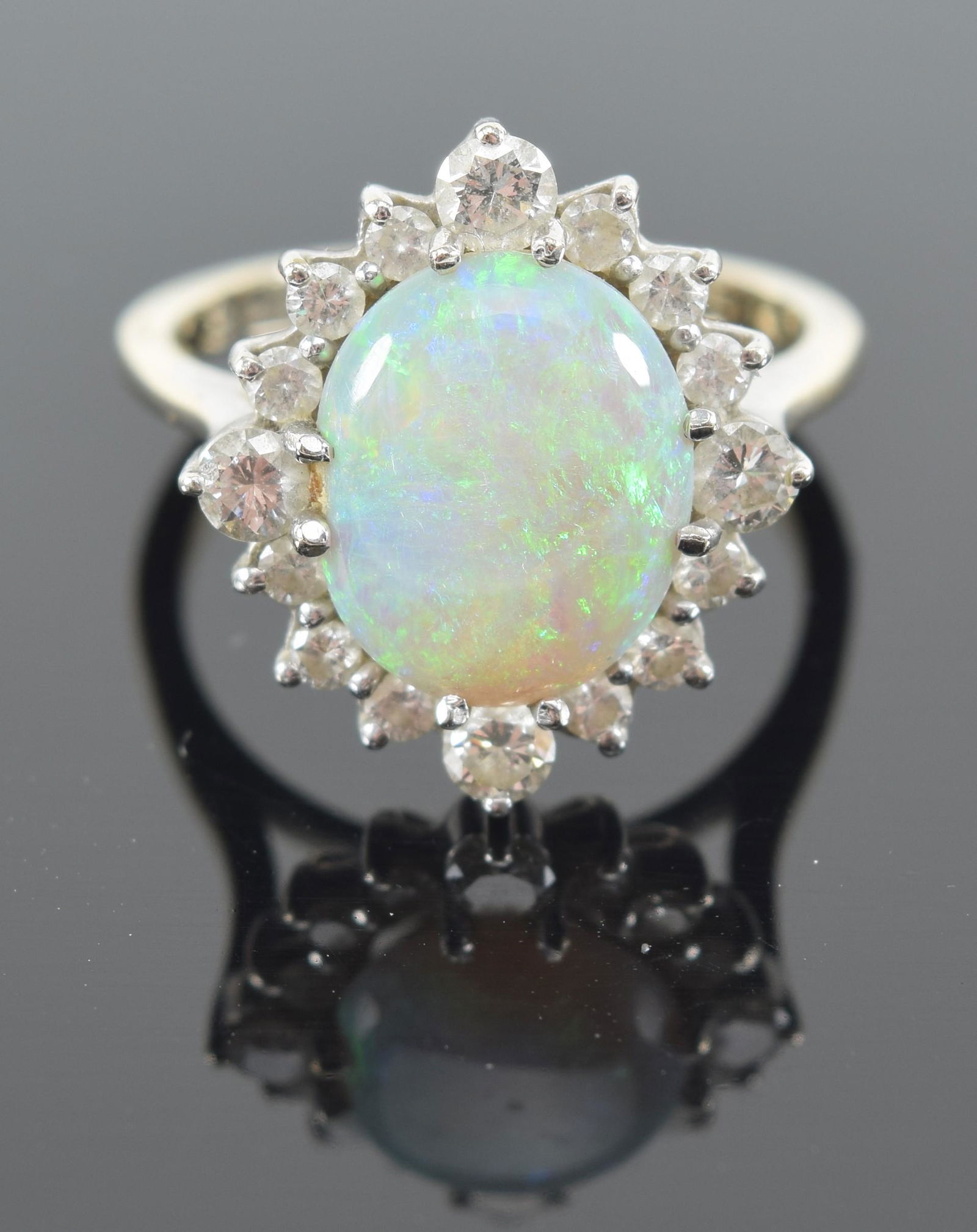 18K gold opal and diamond mounted cluster ring. Fiery opal measures 11.6 x 8.9mm. Marked 18K. (1 of 9)