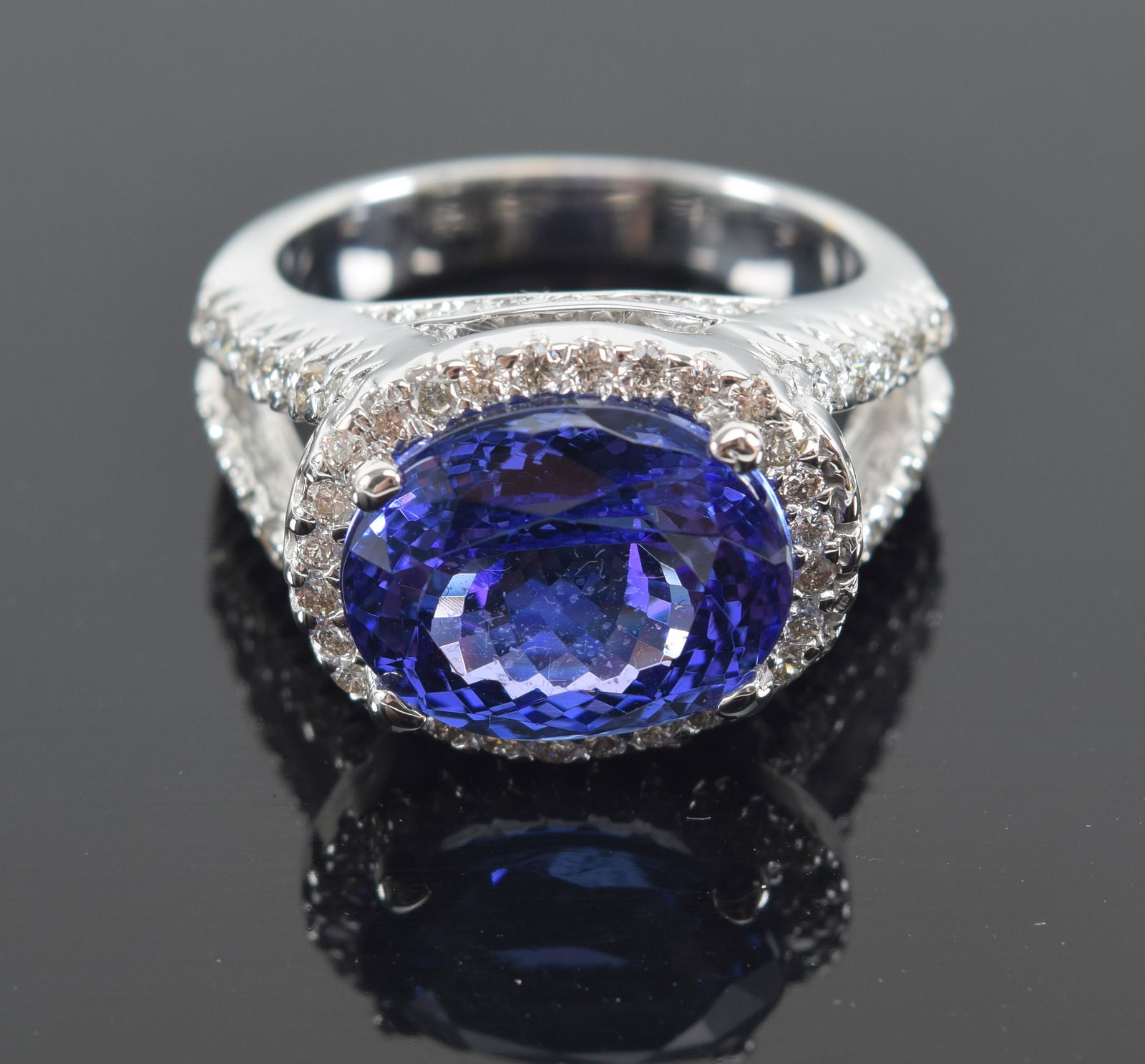 14K gold diamond mounted tanzanite ring. Central stone measuring 12.4 x 10.4mm. Diamonds surround (1 of 7)