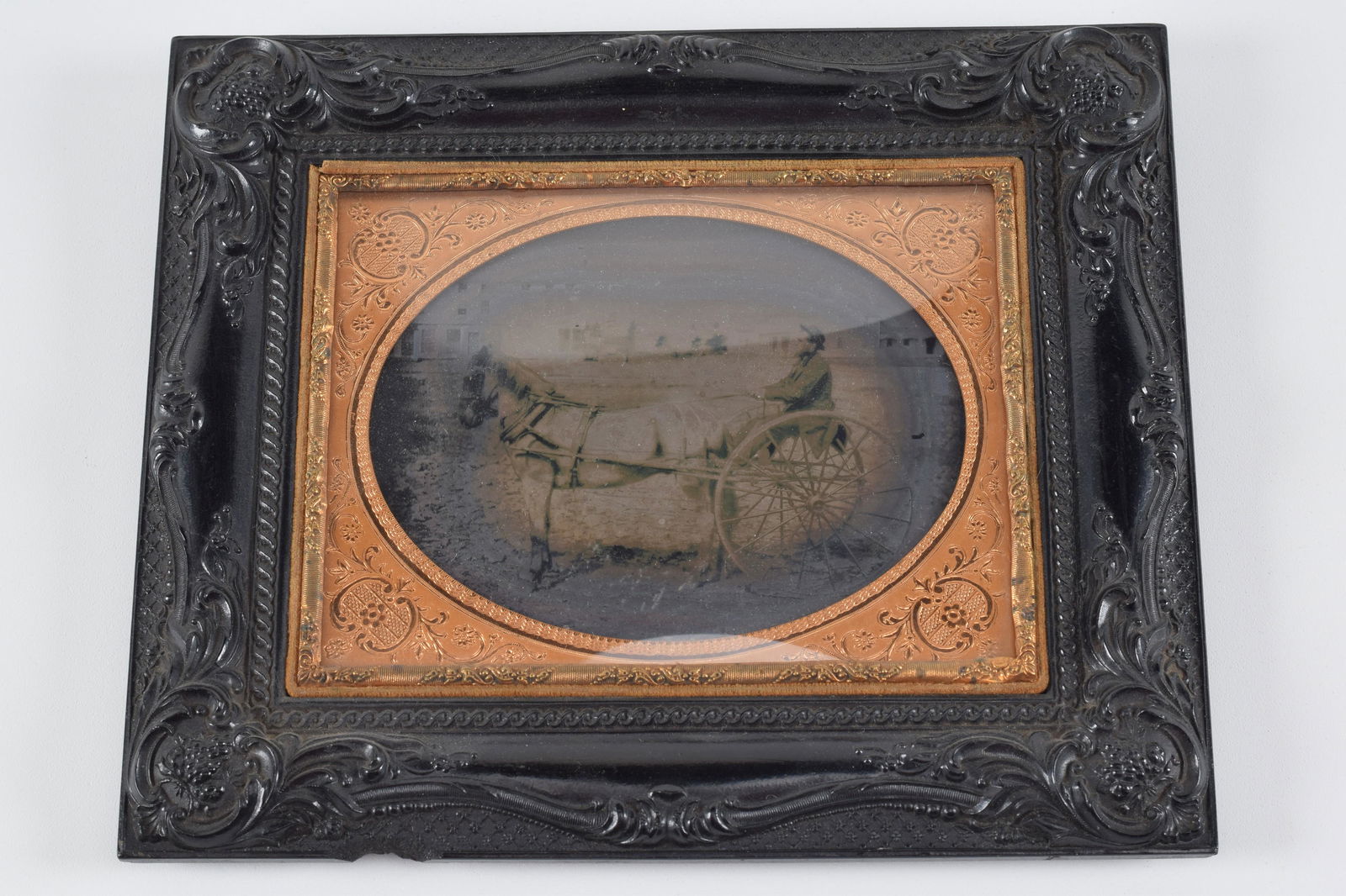 Half plate ambrotype photograph of horse and sulky with rider in exterior scene with buildings. (1 of 5)