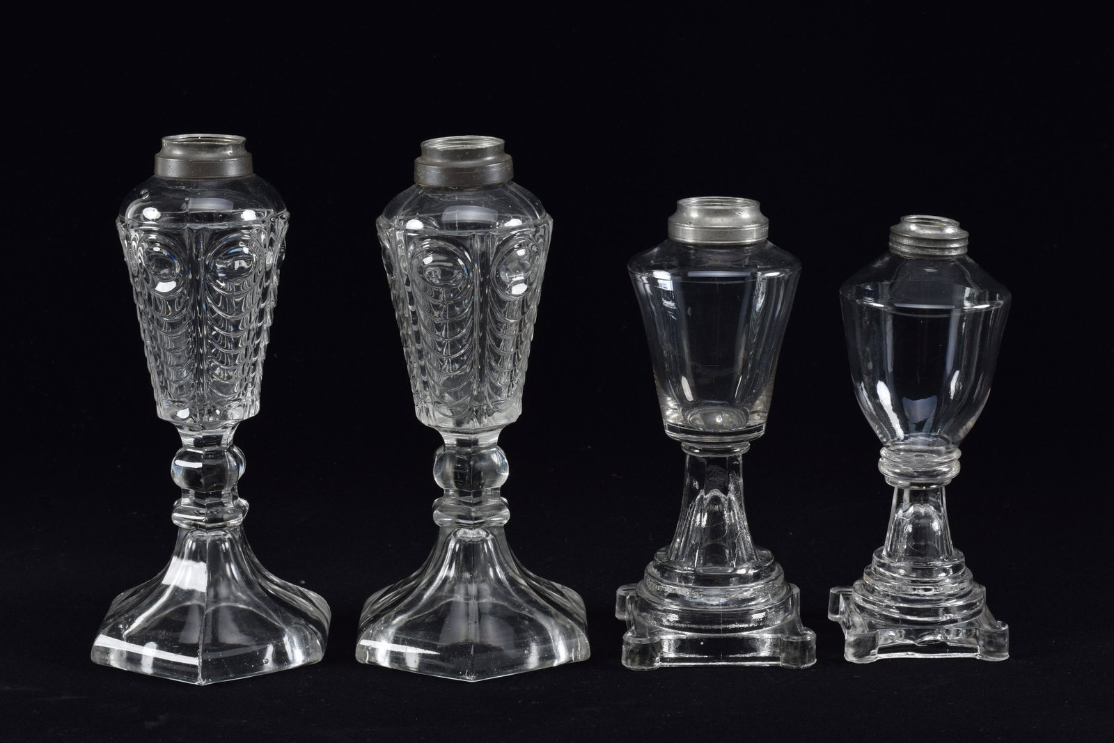 4 Sandwich glass lamps whale oil lamps, mid 19th Century. Including a pair of Eye and Scale pattern.: 4 Sandwich glass lamps whale oil lamps, mid 19th Century. Including a pair of Eye and Scale pattern. No burners. Tallest height 9in