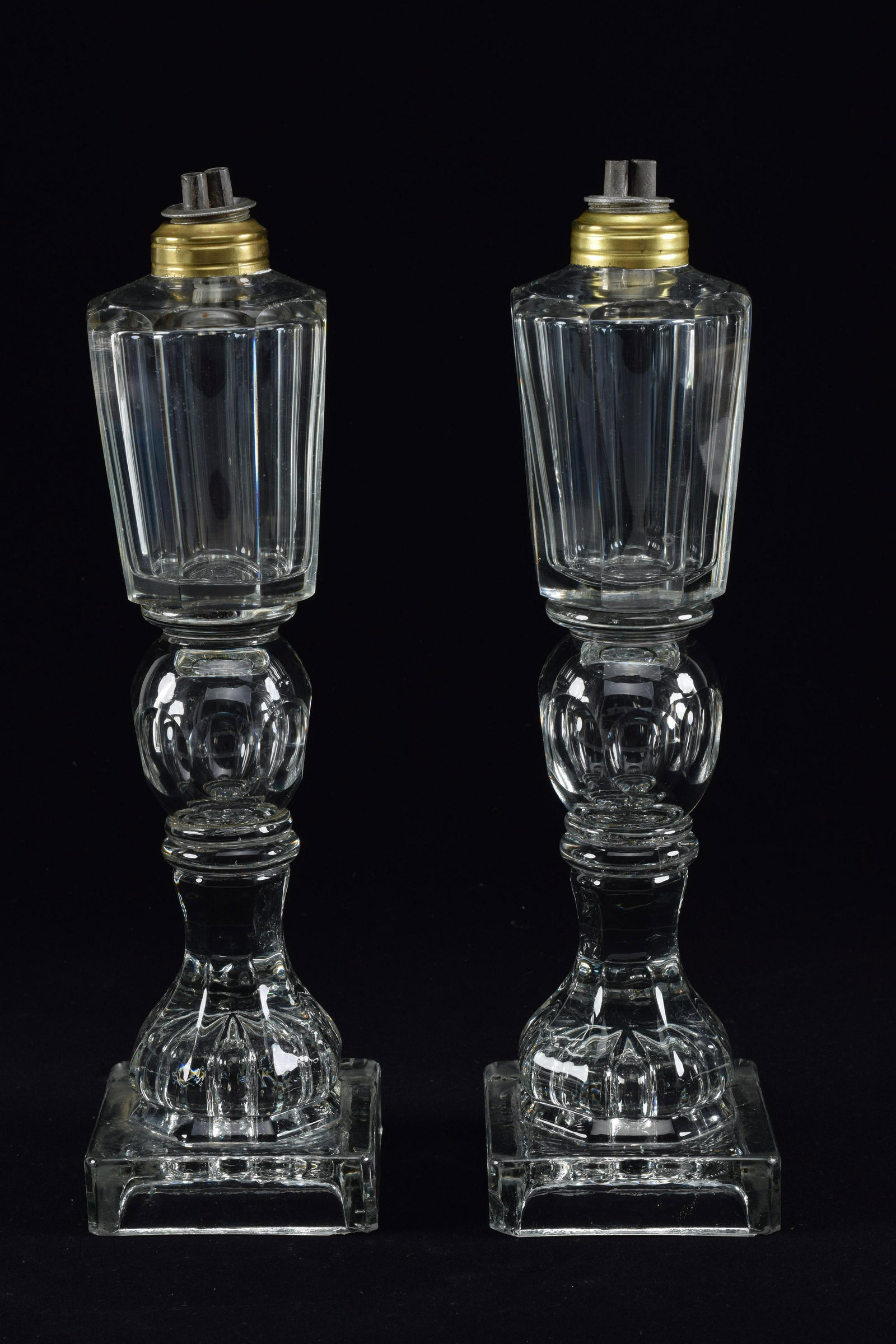 Pair of whale oil lamps, with faceted tops on oval and pressed bases, 19th Century. Height 12.5in: Pair of whale oil lamps, with faceted tops on oval and pressed bases, 19th Century. Height 12.5in