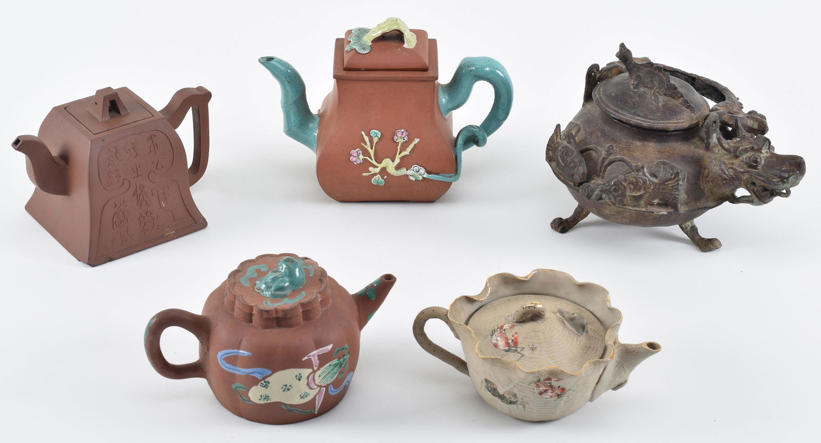Lot of 5 ewers. 3 Yi Hsing tea pots. China. Early 20th century. A bronze vessel from Borneo and a (1 of 12)