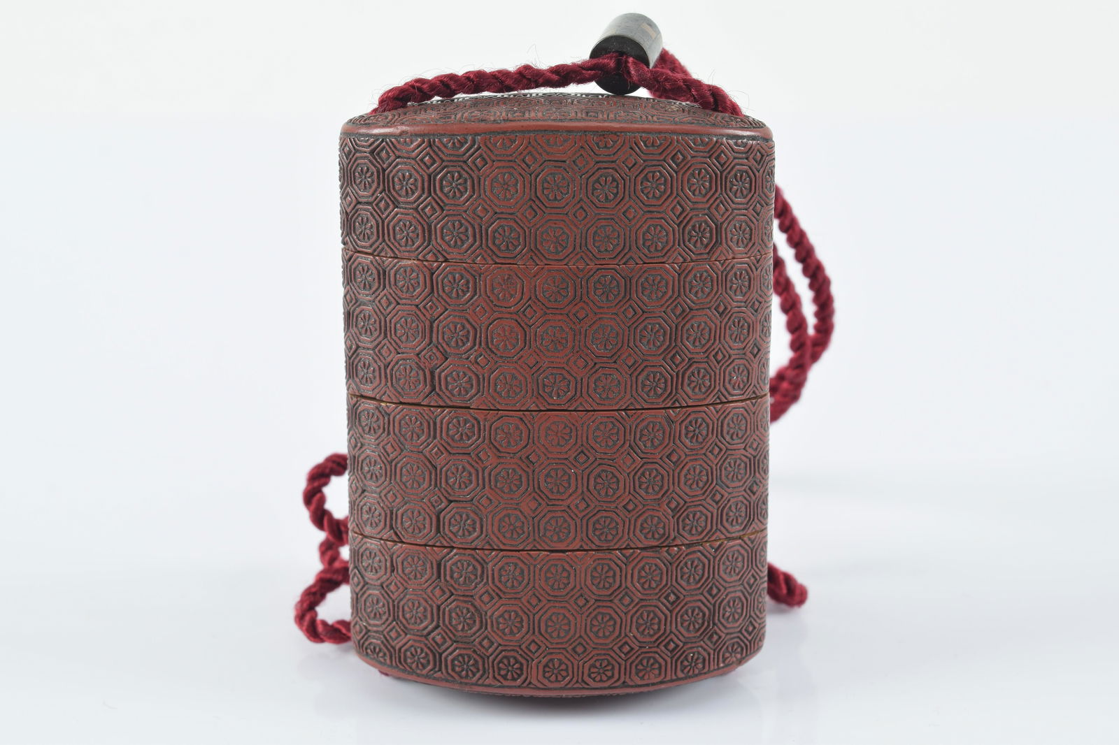 Carved cinnabar lacquer inro. Japan. 19th century. Pattern of brocade. 3in. Provenance: From the (1 of 5)