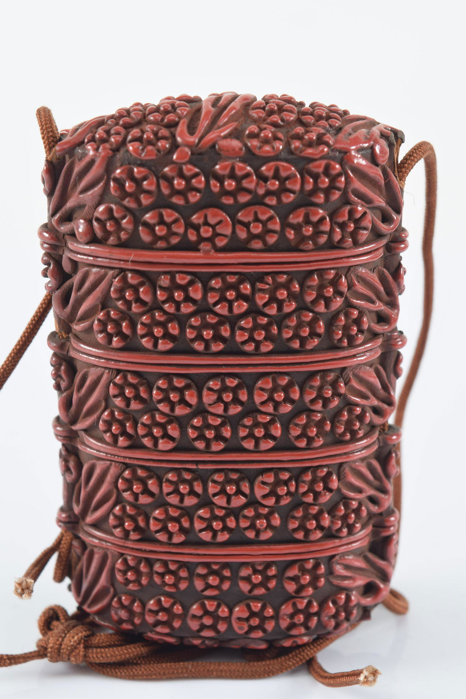 Inro. 4 compartment type. Cinnabar carved surface with flowers and foliage. 3.25in L. Provenance: (1 of 3)