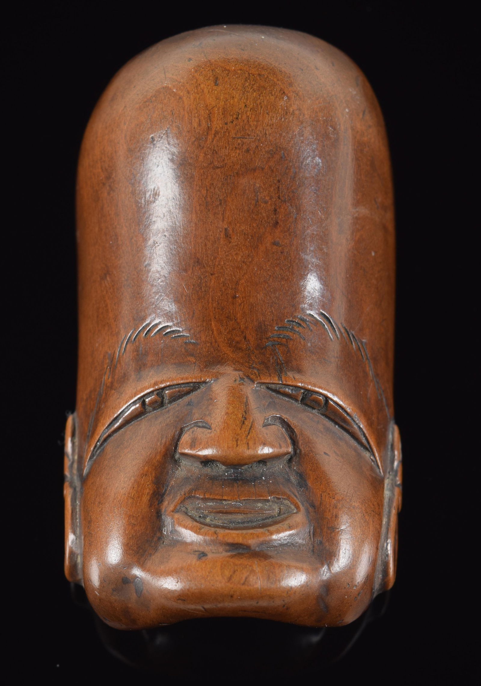 Wooden netsuke. Japan. 19th century. Jurojin mask. Signed. 2.25in. Provenance: From the collection (1 of 3)