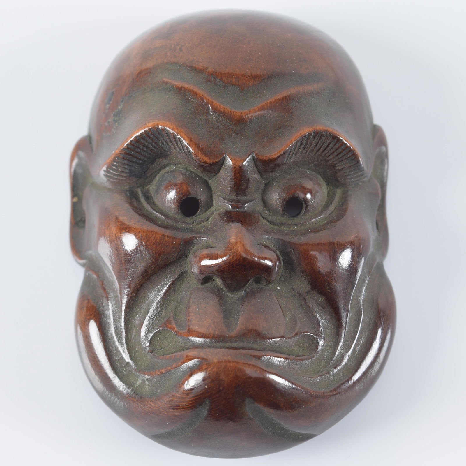 Carved wooden mask netsuke. Japan. 19th century. 2.25in. Provenance: From the collection of Donald (1 of 3)