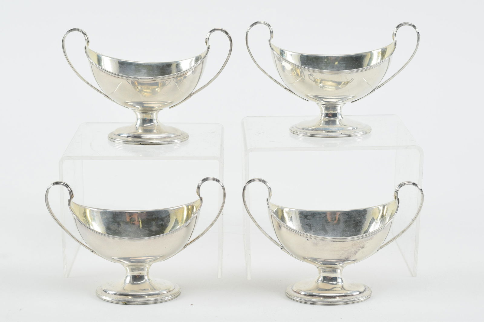 4 Georgian sterling silver master salts. Classical form with large open handles and footed bases. (1 of 8)
