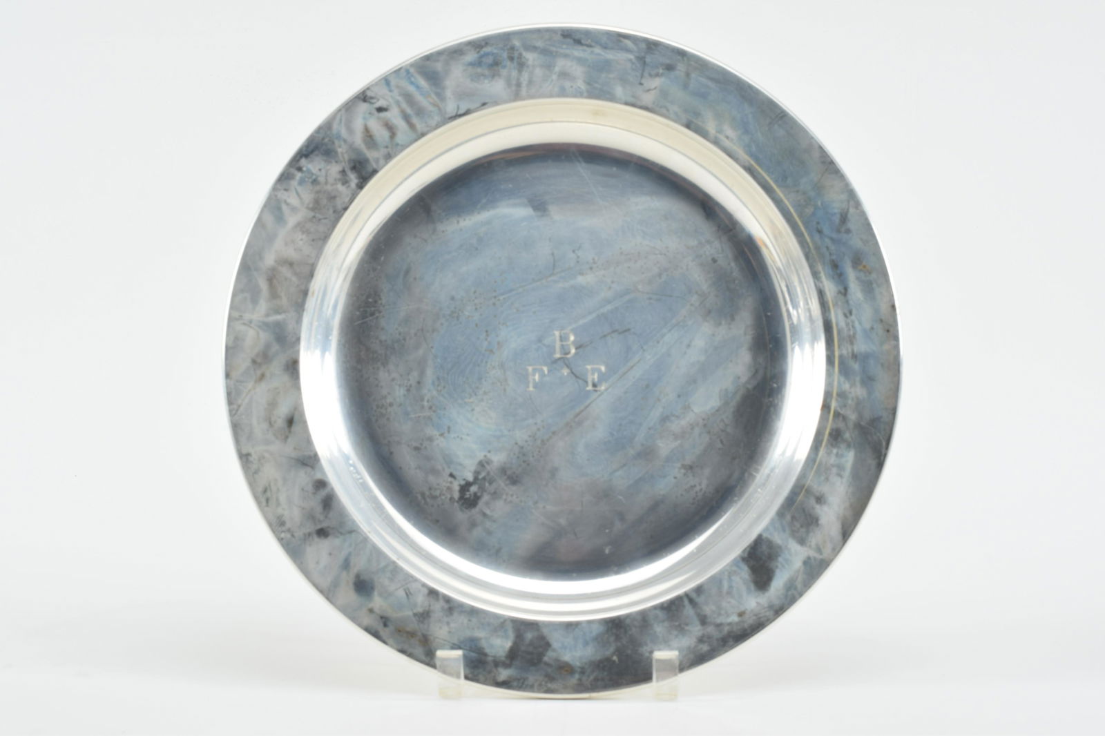 Shreve Crump & Low sterling silver charger. John Coburn, Boston, reproduction. Wide rim. Monogrammed: Shreve Crump & Low sterling silver charger. John Coburn, Boston, reproduction. Wide rim. Monogrammed F.B.E.; 25.8 ozt. 13in diameter.