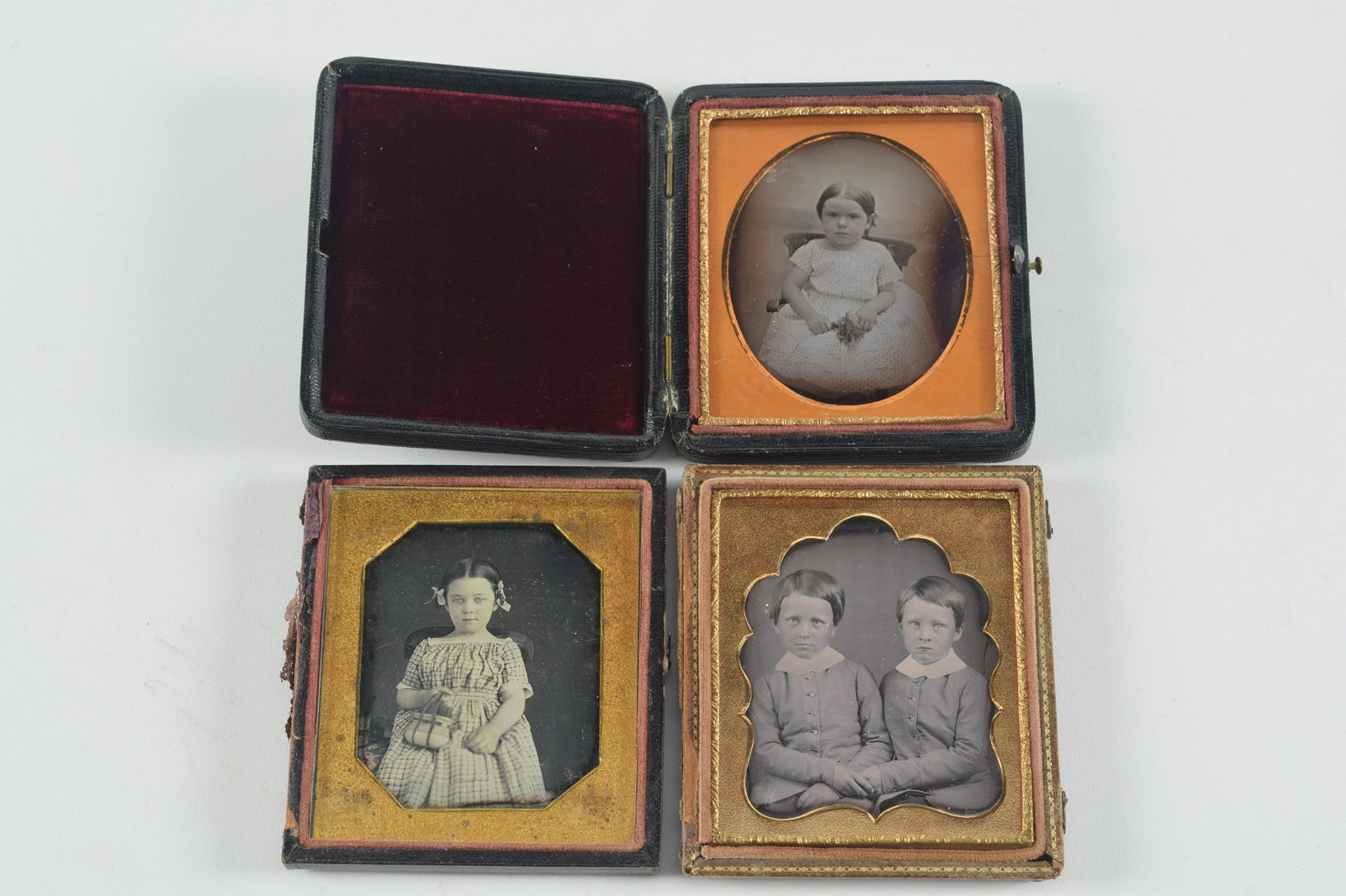 3 sixth plate daguerreotype photographs of young children. To include: 1) Young girl in plaid dress (1 of 6)