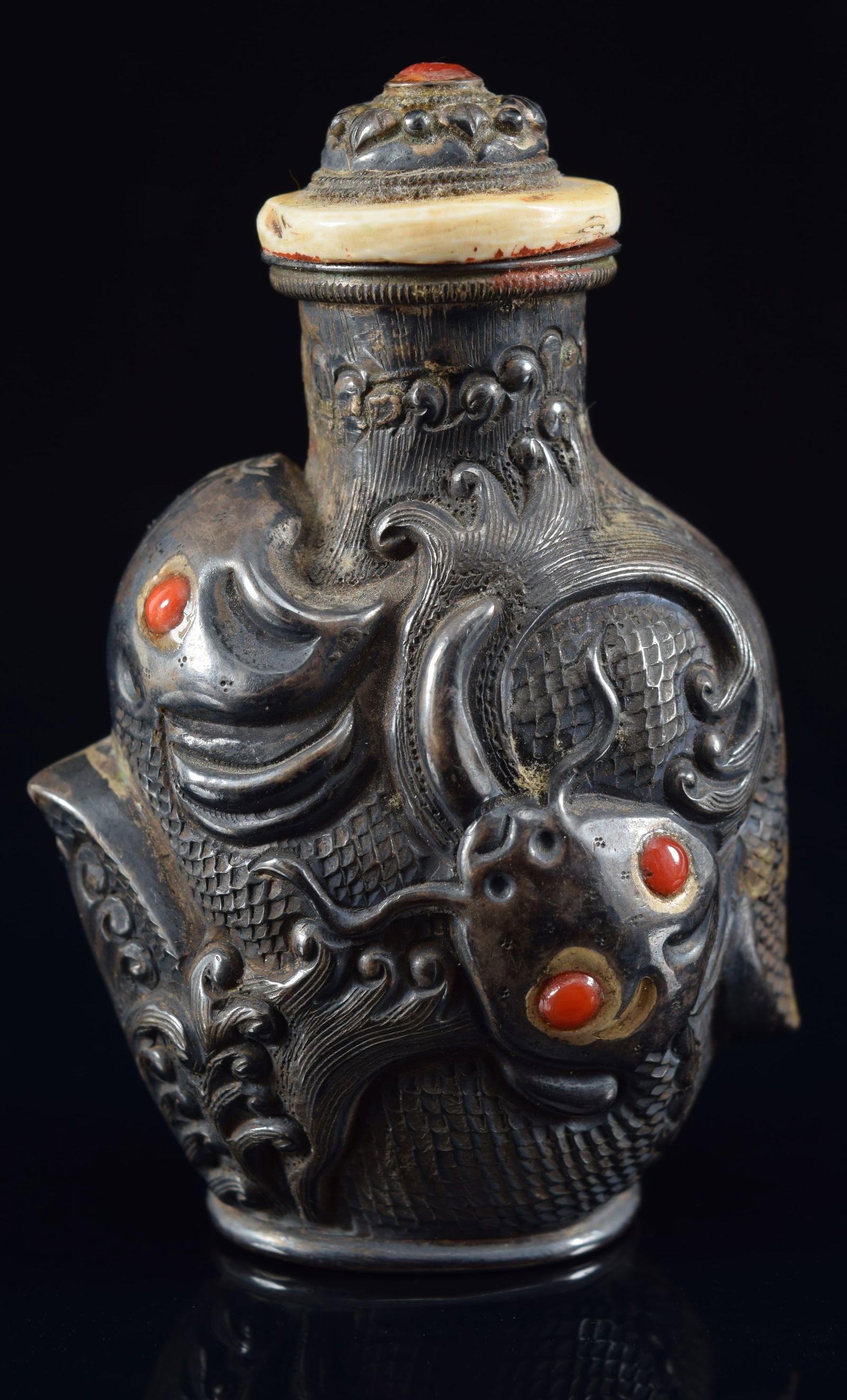 Silver snuff bottle. China. 19th century. Repousse decoration of fish with red glass inlays. (1 of 6)