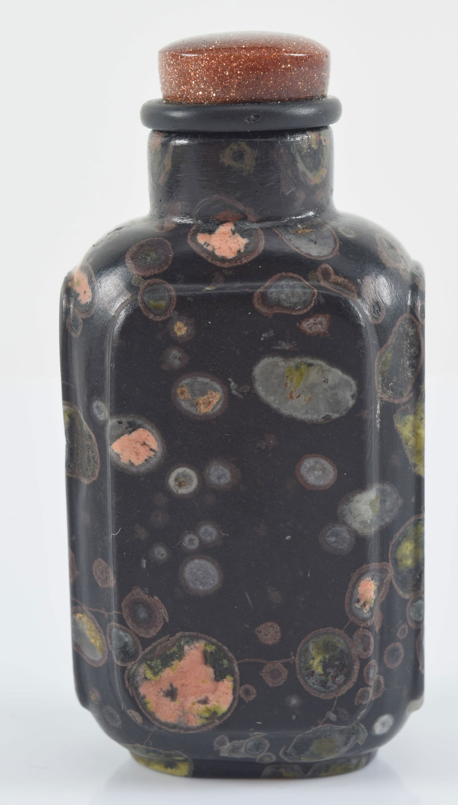 Puddingstone snuff bottle. China. 19th century. Facetted sides. 2.25in H. Provenance: The Mitchell (1 of 6)