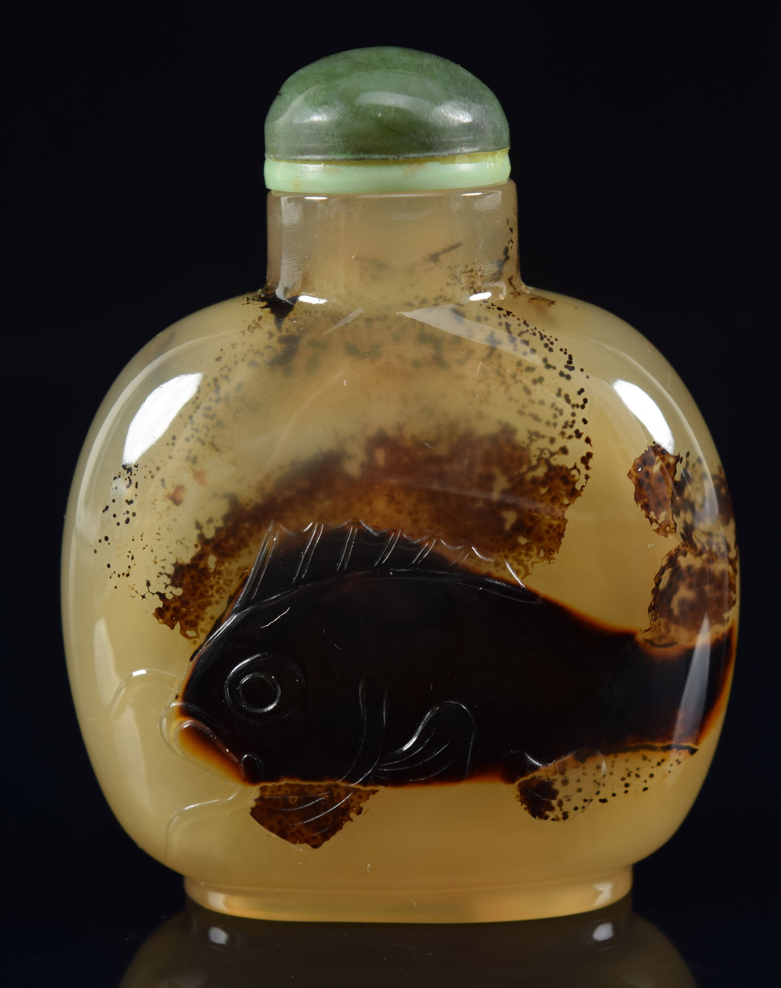Shadow agate snuff bottle. China. 19th century. Surface carved with a fish. 2.25in H. Provenance: (1 of 6)