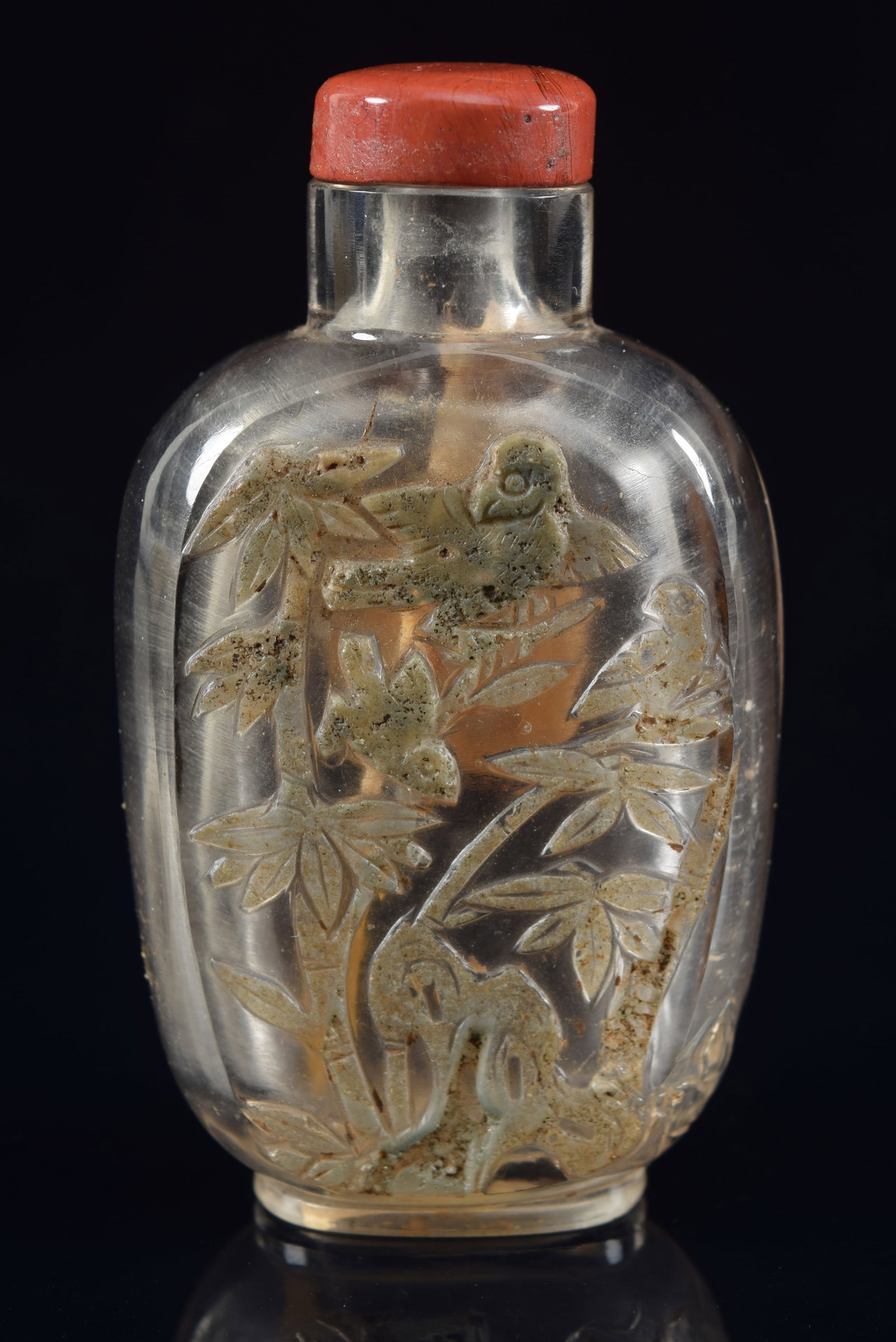 Rock crystal snuff bottle. China. 19th century. Natural skin carved with birds and flowers. 2.75in: Rock crystal snuff bottle. China. 19th century. Natural skin carved with birds and flowers. 2.75in H. Provenance: The Mitchell Bistany Collection.