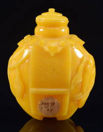 Imperial workshop snuff bottle. China. 19th century. Yellow glass carved as a caparisoned elephant.