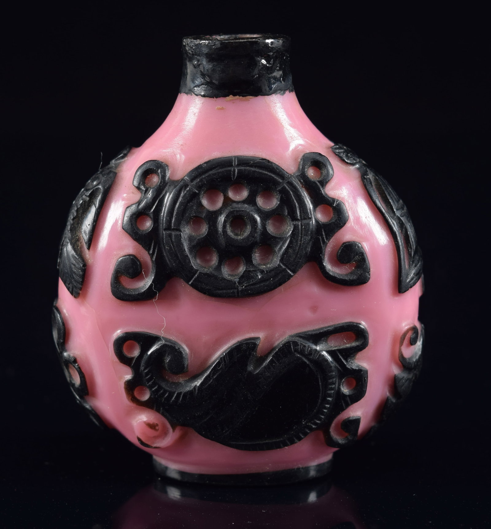 Peking glass snuff bottle. China. 19th century. Cameo cut black to pink with the buddhist "8: Peking glass snuff bottle. China. 19th century. Cameo cut black to pink with the buddhist "8 precious emblems". 2.5in H. Repair to lip. Provenance: The Mitchell Bistany Collection.