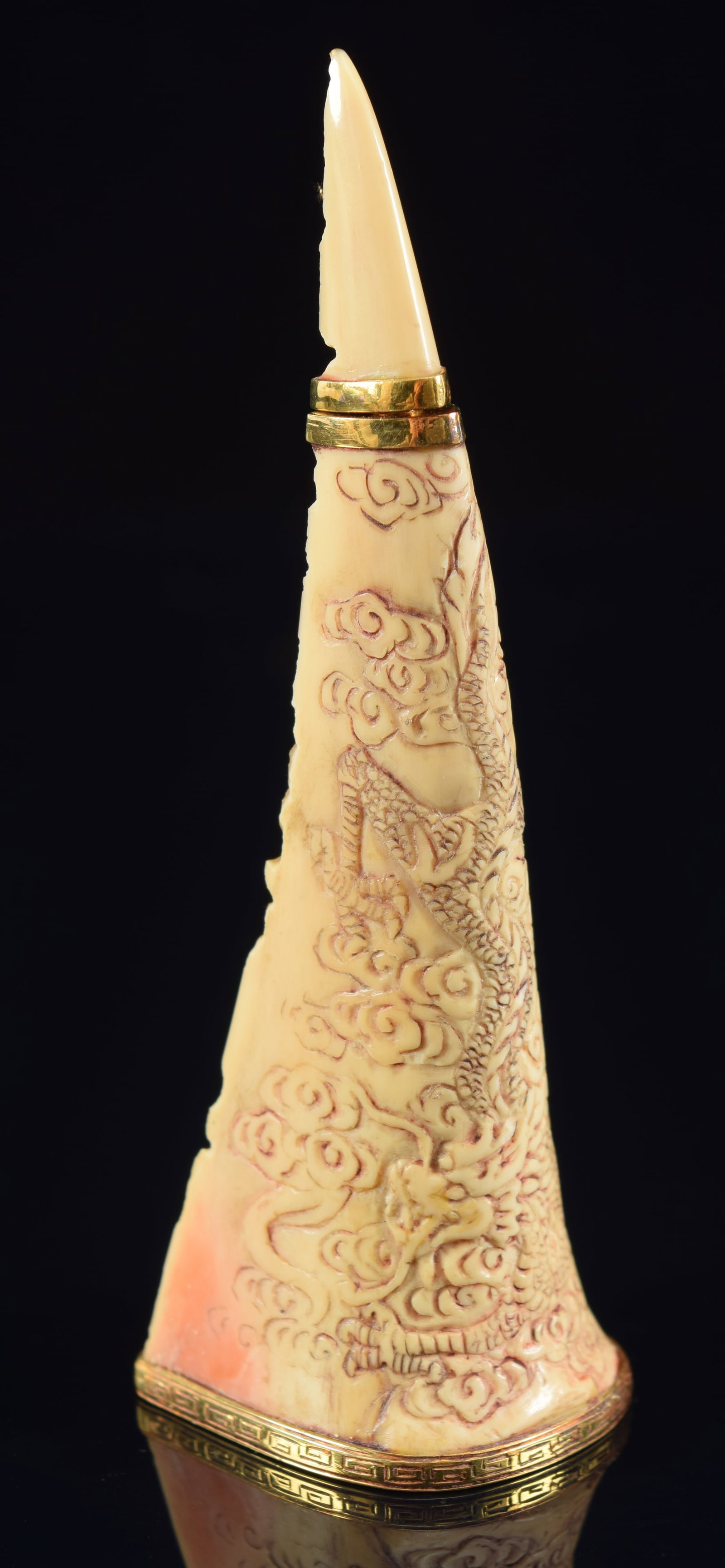 Hornbill snuff. China. 19th century. Surface carved with dragons. Gold mountings. 3.75in H.: Hornbill snuff. China. 19th century. Surface carved with dragons. Gold mountings. 3.75in H. Provenance: The Mitchell Bistany Collection.