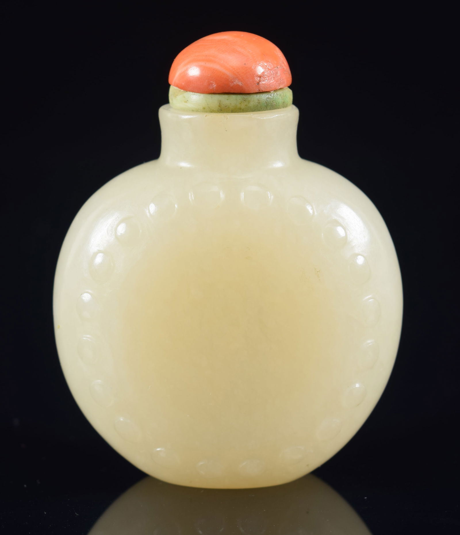 White jade snuff bottle. China. 18th century. Drum shaped. Coral stopper. 2.125in H. Provenance: The (1 of 7)