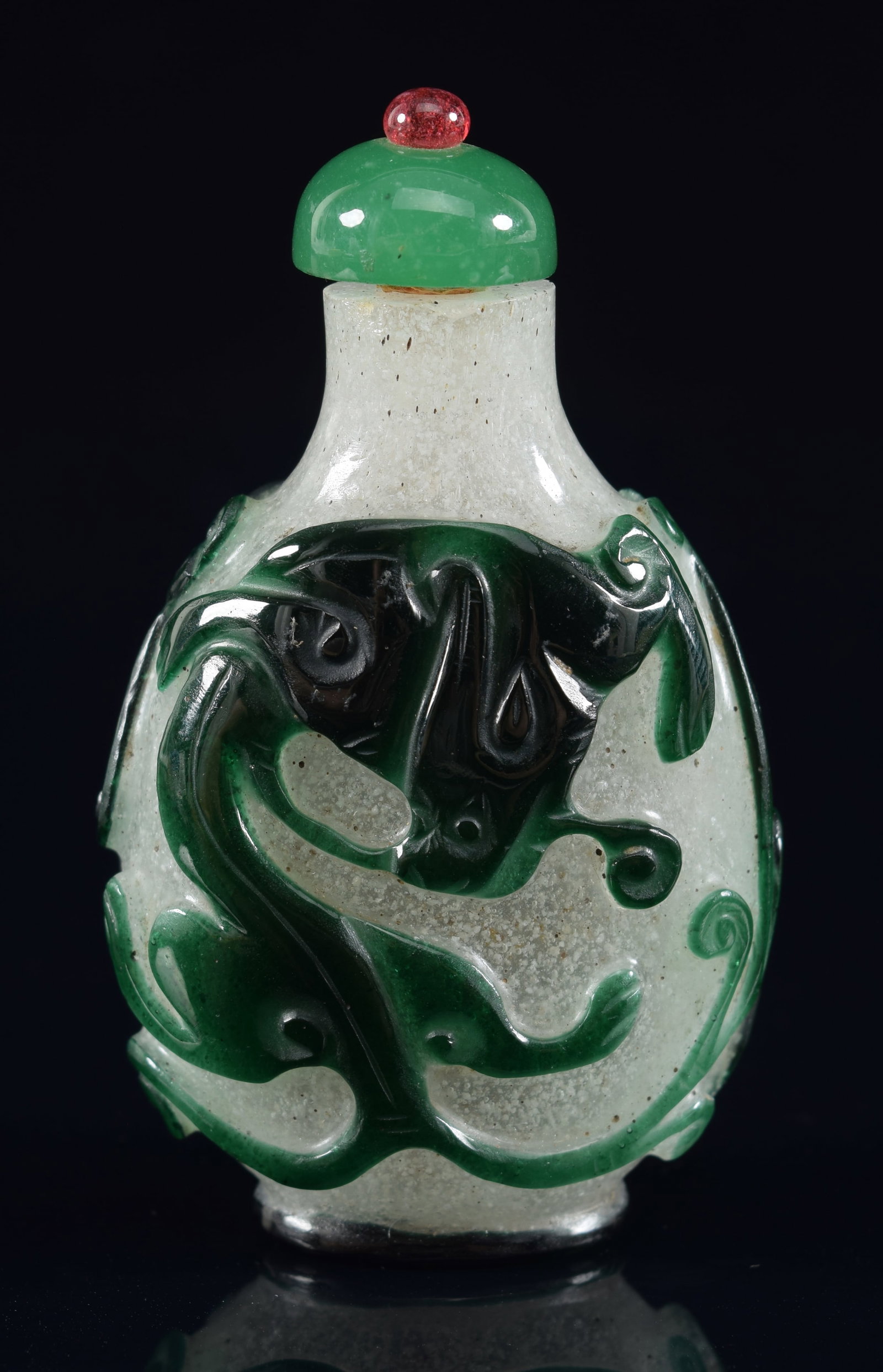 Peking glass snuff bottle. China. 19th century. Cameo cut green to snowflake with chih lung. Rough: Peking glass snuff bottle. China. 19th century. Cameo cut green to snowflake with chih lung. Rough edge to the mouth. 2.5in H. Provenance: The Mitchell Bistany Collection.