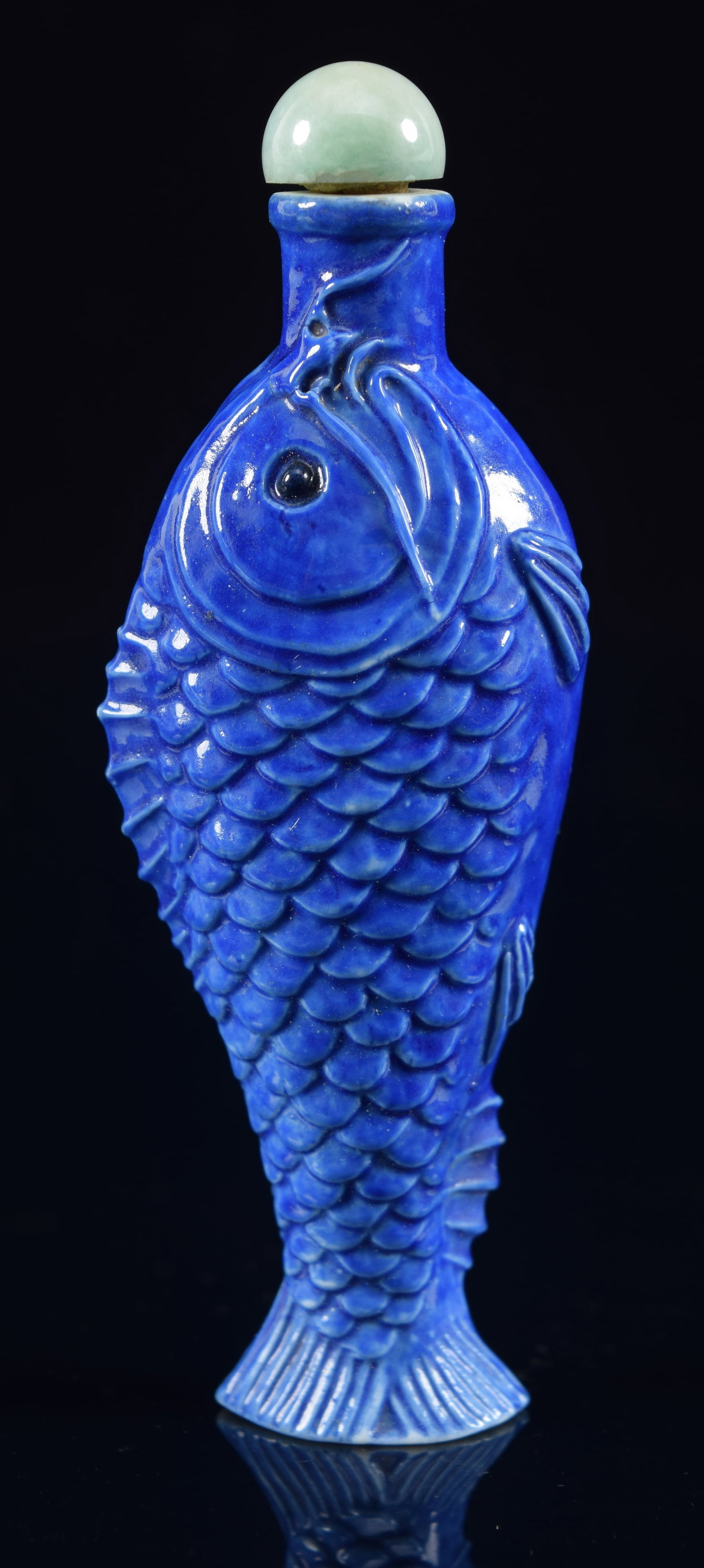Porcelain snuff bottle. China. 19th century. Fish form. Blue glaze. Jade stopper. 3in H. Provenance:: Porcelain snuff bottle. China. 19th century. Fish form. Blue glaze. Jade stopper. 3in H. Provenance: The Mitchell Bistany Collection.