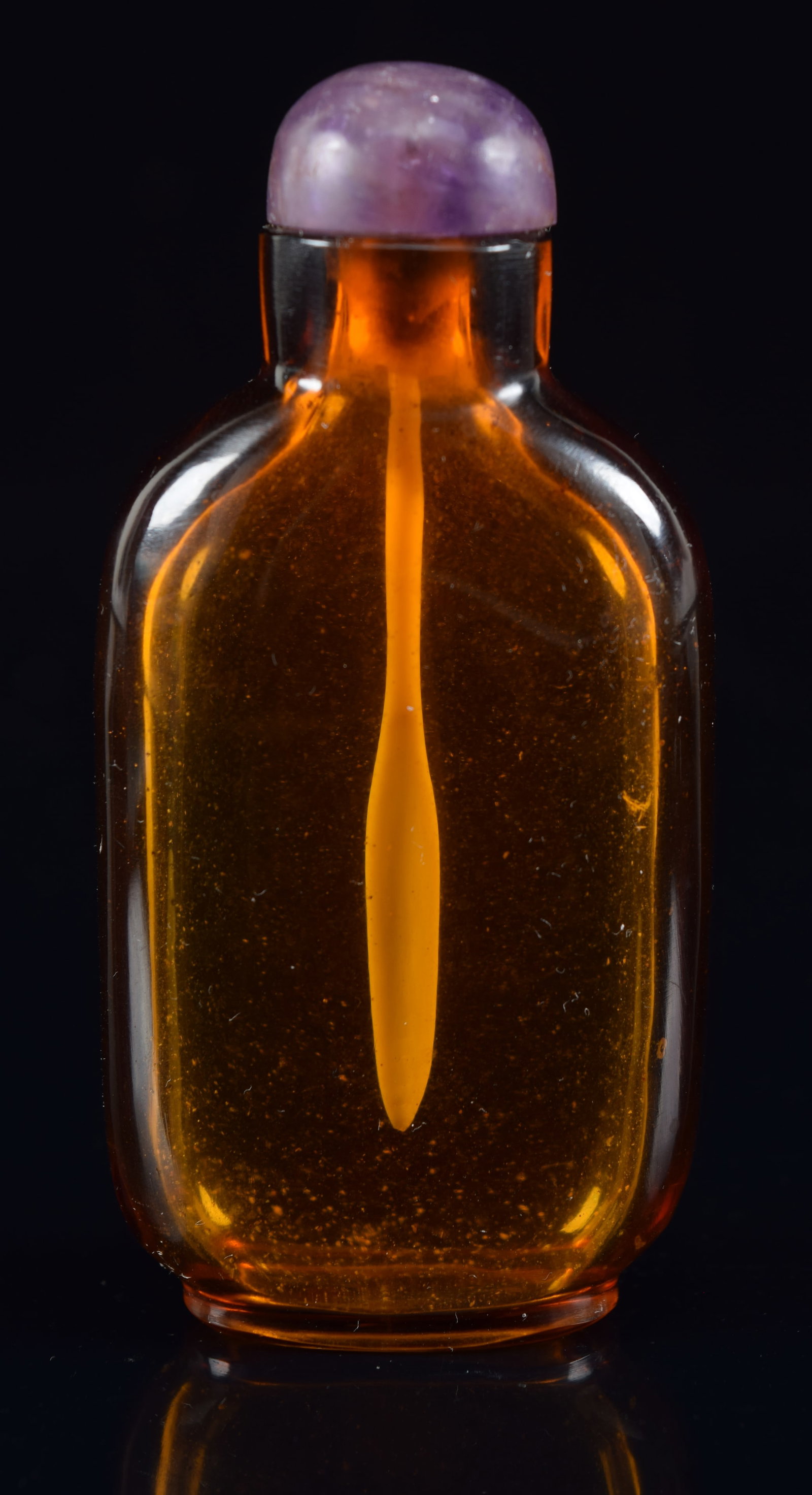 Peking glass snuff bottle. China. 19th century. Flattened rectangular form. Clear amber color. (1 of 6)