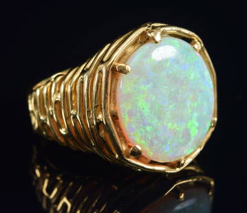 18K gold opal mounted ring with naturalistic design. Opal measures 16.3mm round. Ring size 7.25.: 18K gold opal mounted ring with naturalistic design. Opal measures 16.3mm round. Ring size 7.25. Marked 18CT. 19.1 grams.