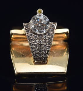 14K gold diamond designer ring. Heavy modern design with 6mm round diamond (approximately slightly: 14K gold diamond designer ring. Heavy modern design with 6mm round diamond (approximately slightly less than 1ct) in triangular diamond pave setting with a tiny yellow diamond mounted above.