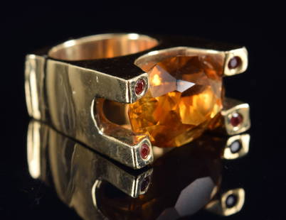 Heavy 14K gold brutalist designer ring with large oval faceted orange stone, possibly a topaz, set: Heavy 14K gold brutalist designer ring with large oval faceted orange stone, possibly a topaz, set between 4 tiny orange/red stones at the corners. Unmarked, tests as 14K. 22.9 grams. Ring size 3.5.