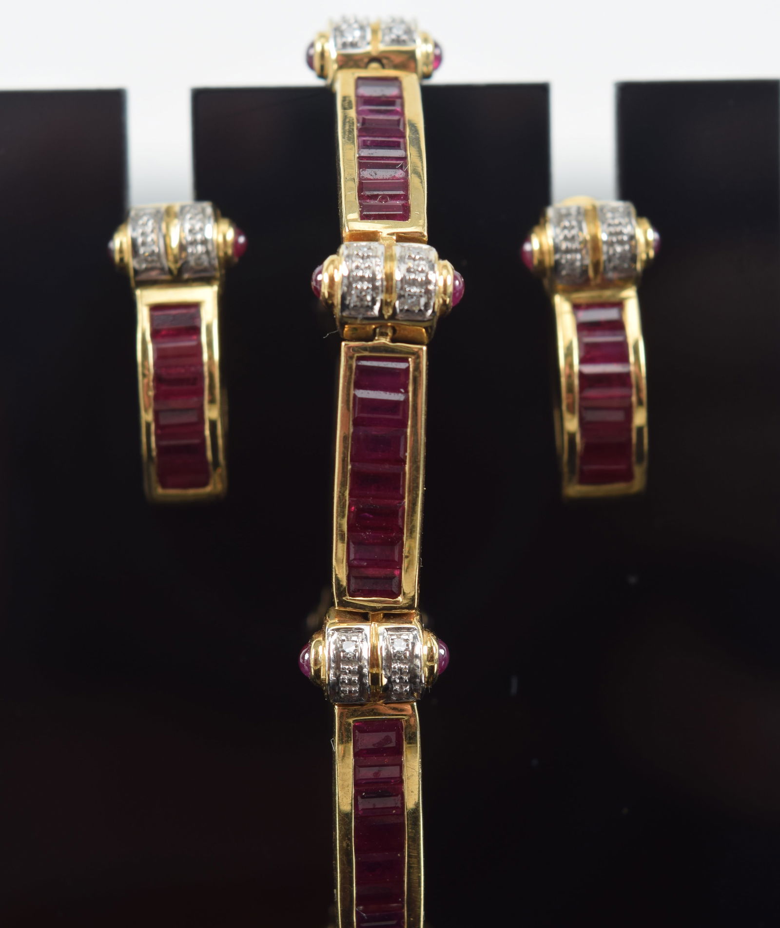 18K gold ruby and diamond bracelet and earrings set. 9 alternating sections of 7 rubies (each about (1 of 9)