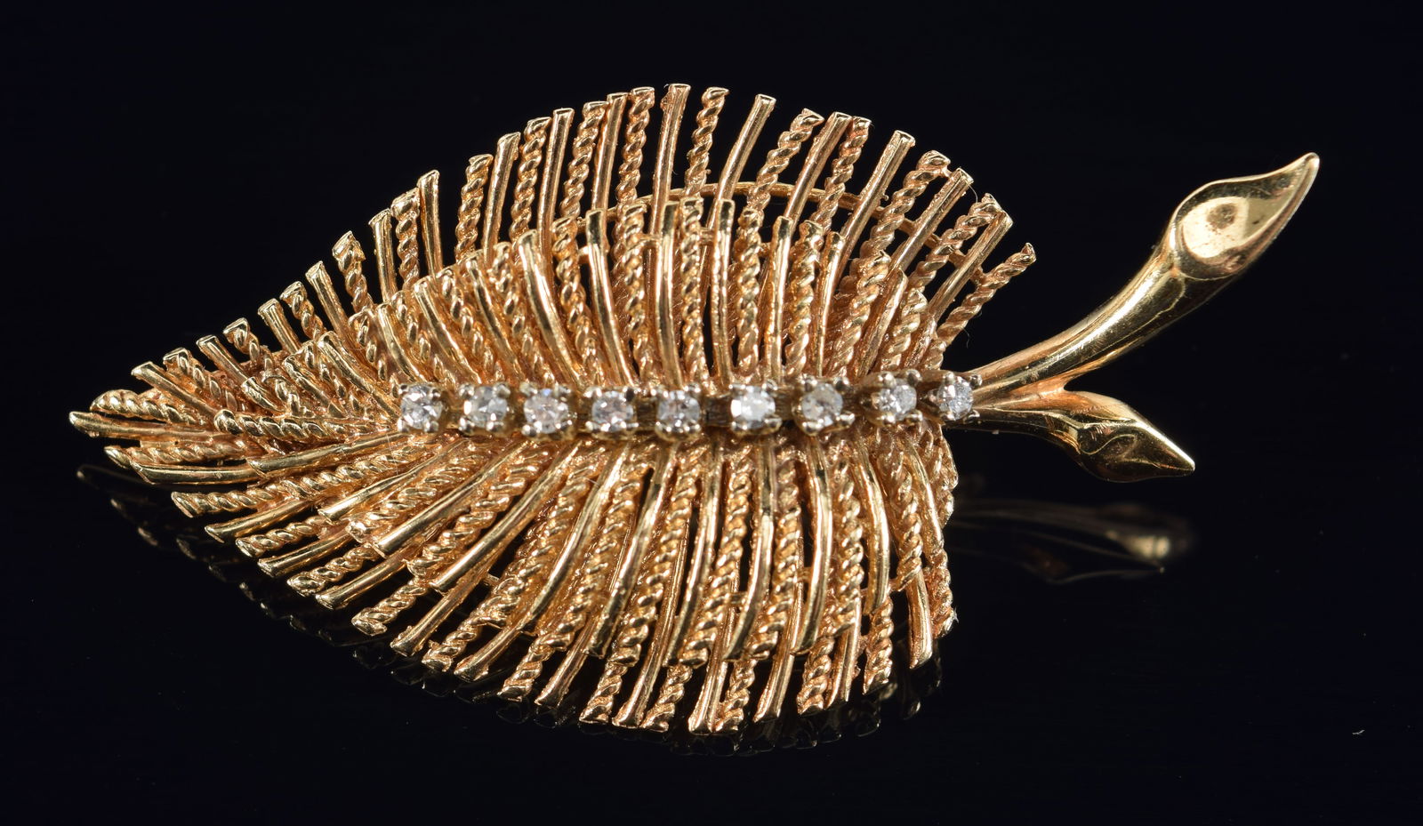 14K gold diamond mounted leaf form pin. Central row of 9 small round cut diamonds in white gold. (1 of 4)