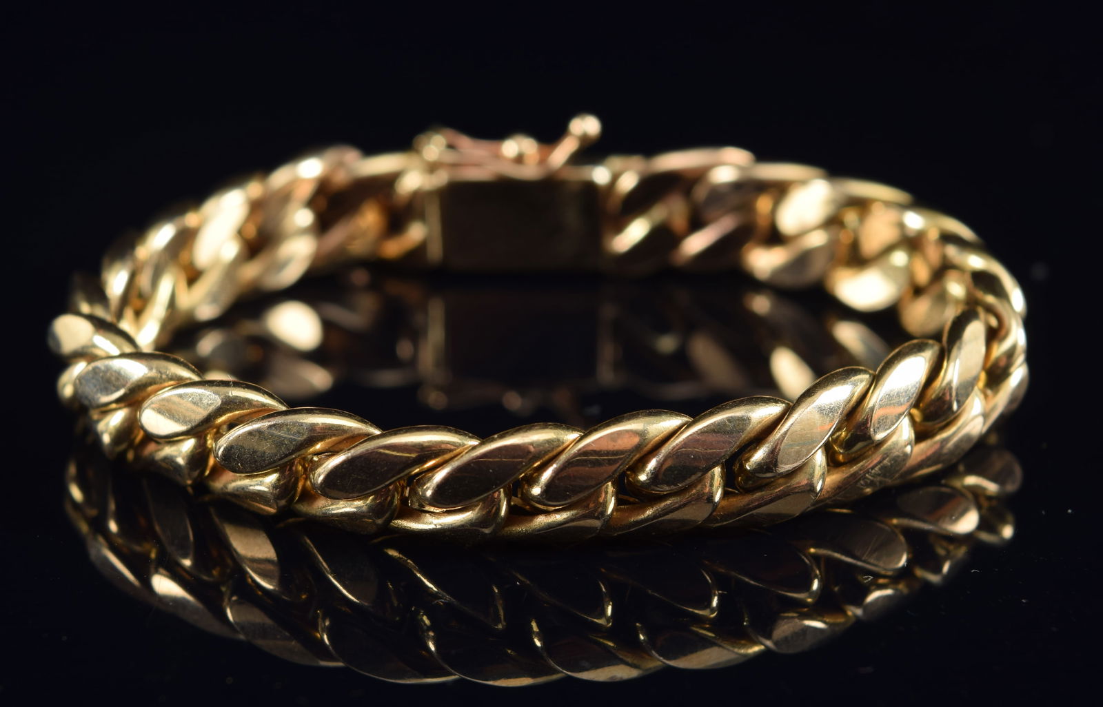 14K gold Cuban chain bracelet. 5.5in length. 9.7 grams. Marked 14K on clasp. (1 of 3)