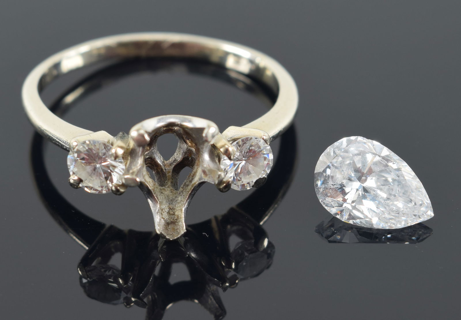 14K gold diamond mounted ring. Approx. 1.4ct pear shape diamond flanked by 2 approx. 0.30ct round (1 of 6)