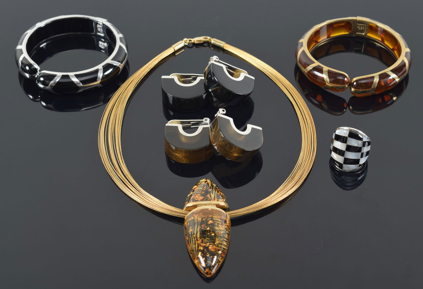 Signed sterling silver jewelry. To include: 1) "SH" sterling silver and amber-like resin pendant and (1 of 7)