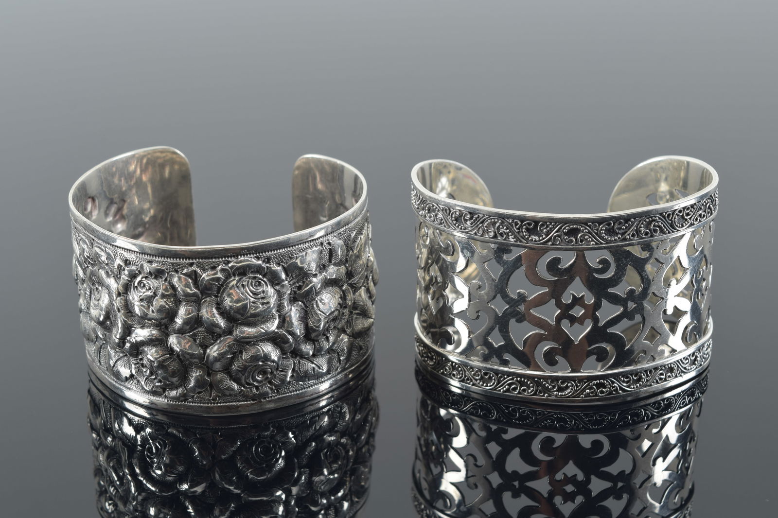 2 sterling silver cuff bracelets. 1 repousse floral decoration, the other reticulated. Each about (1 of 5)