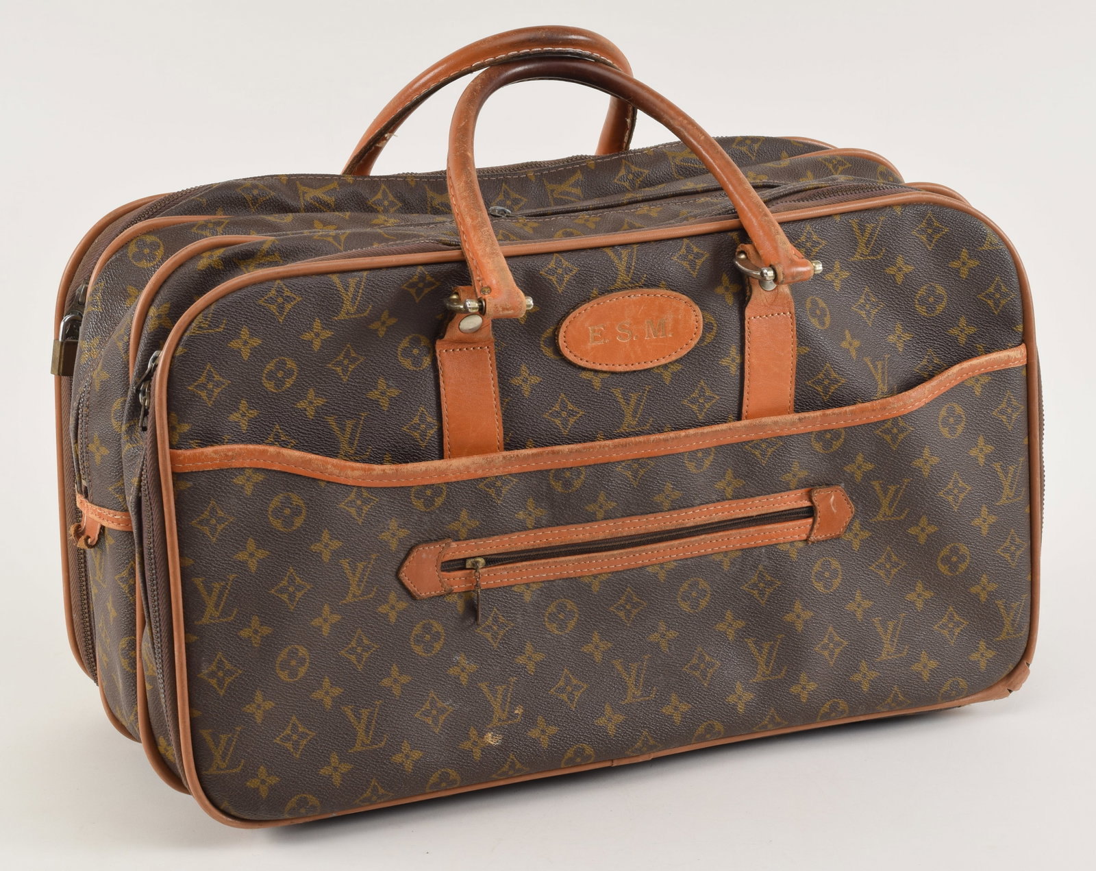 Vintage Louis Vuitton travel bag. Leather trim and handles. Interior in good condition with some: Vintage Louis Vuitton travel bag. Leather trim and handles. Interior in good condition with some light marks/stains. 22 W x 12.5 x 10in.