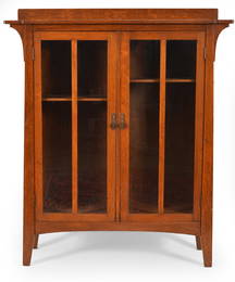 Limbert mission oak 2-door bookcase, ca. 1910. Canted sides with brackets and glazed cabinet doors